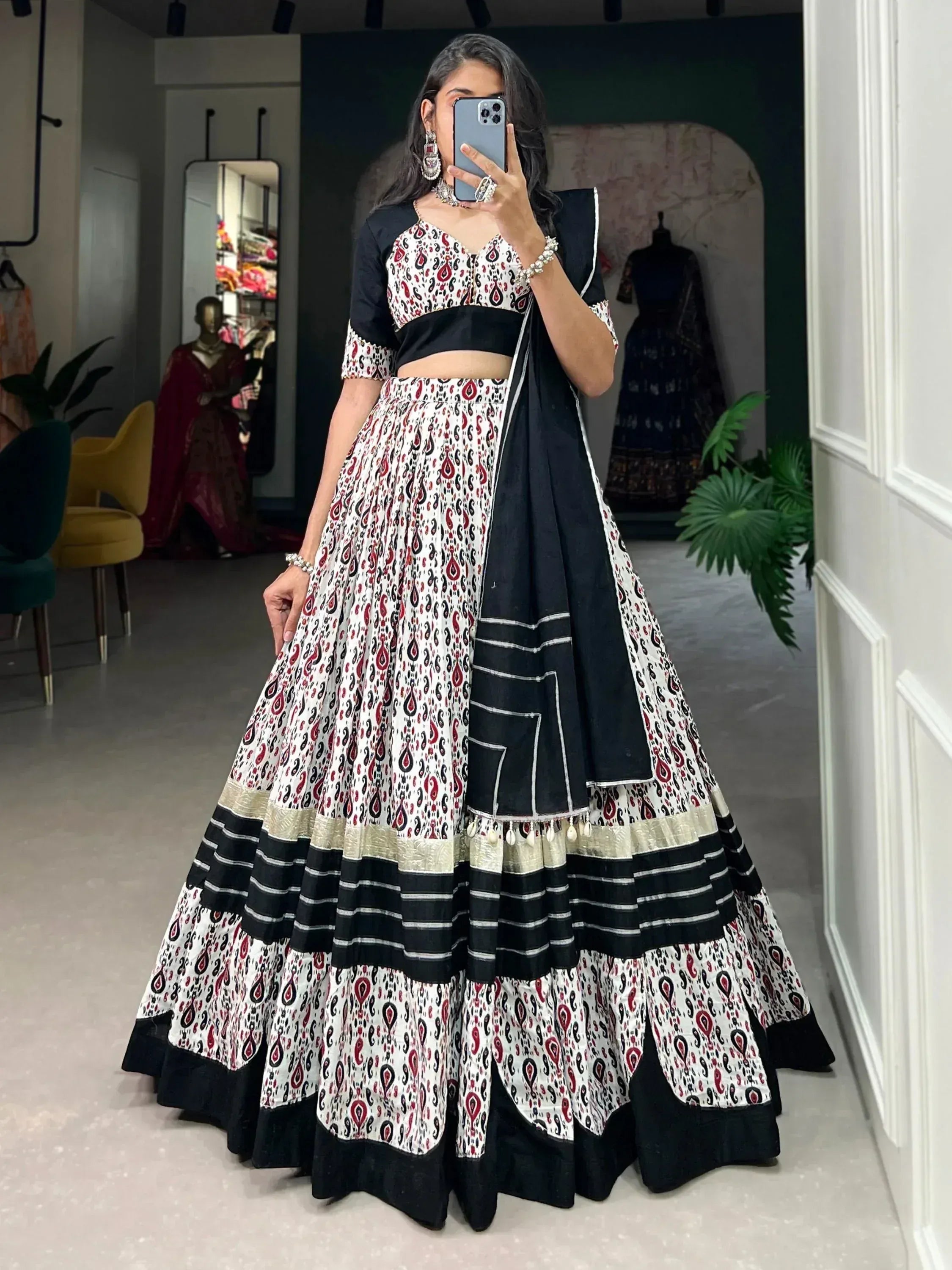 Woman wearing black and white printed lehenga choli with paisley design, perfect for ethnic occasions