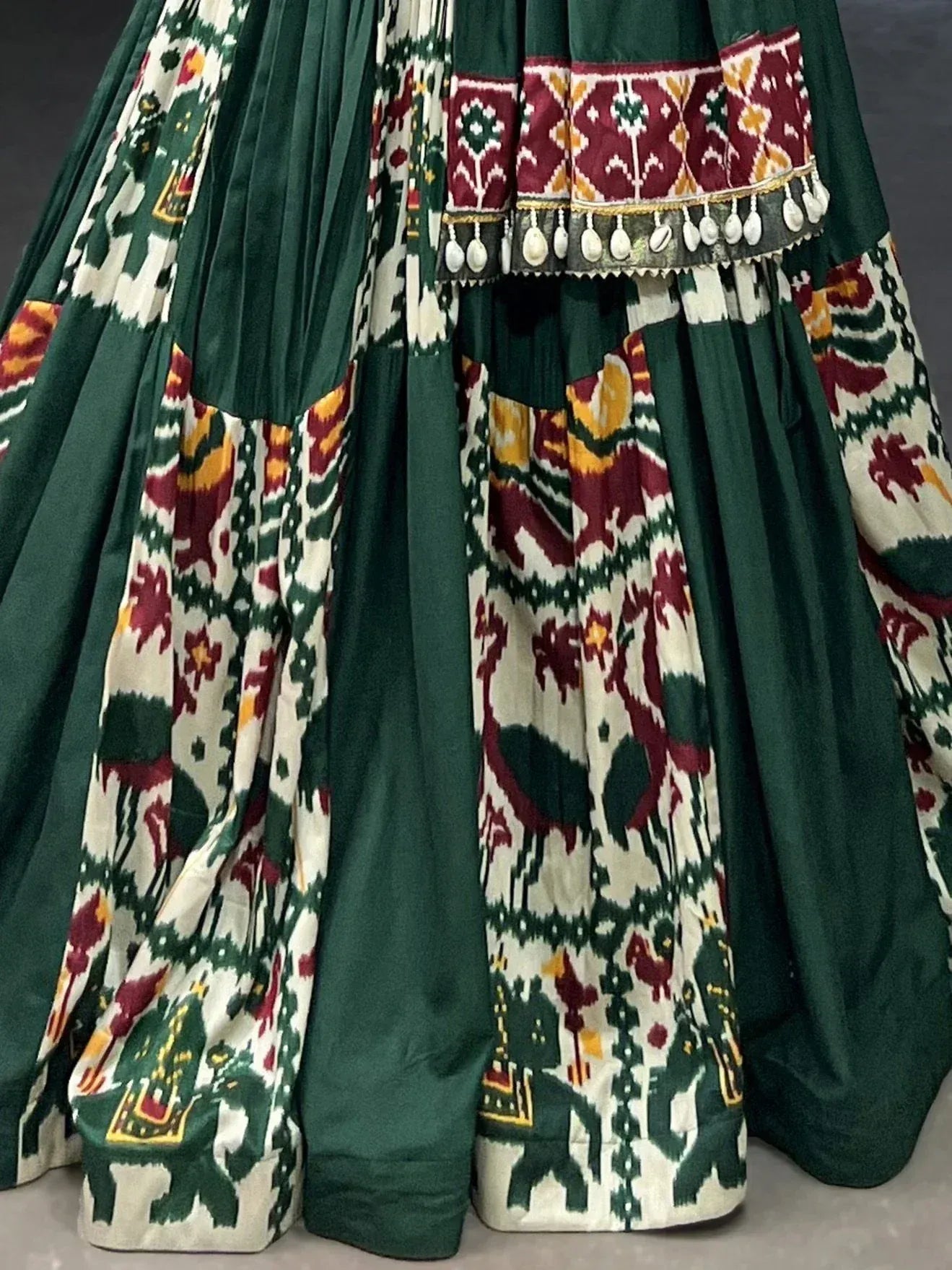 Green and cream Ikat lehenga with elephant motifs and tassel border, ethnic Indian wear