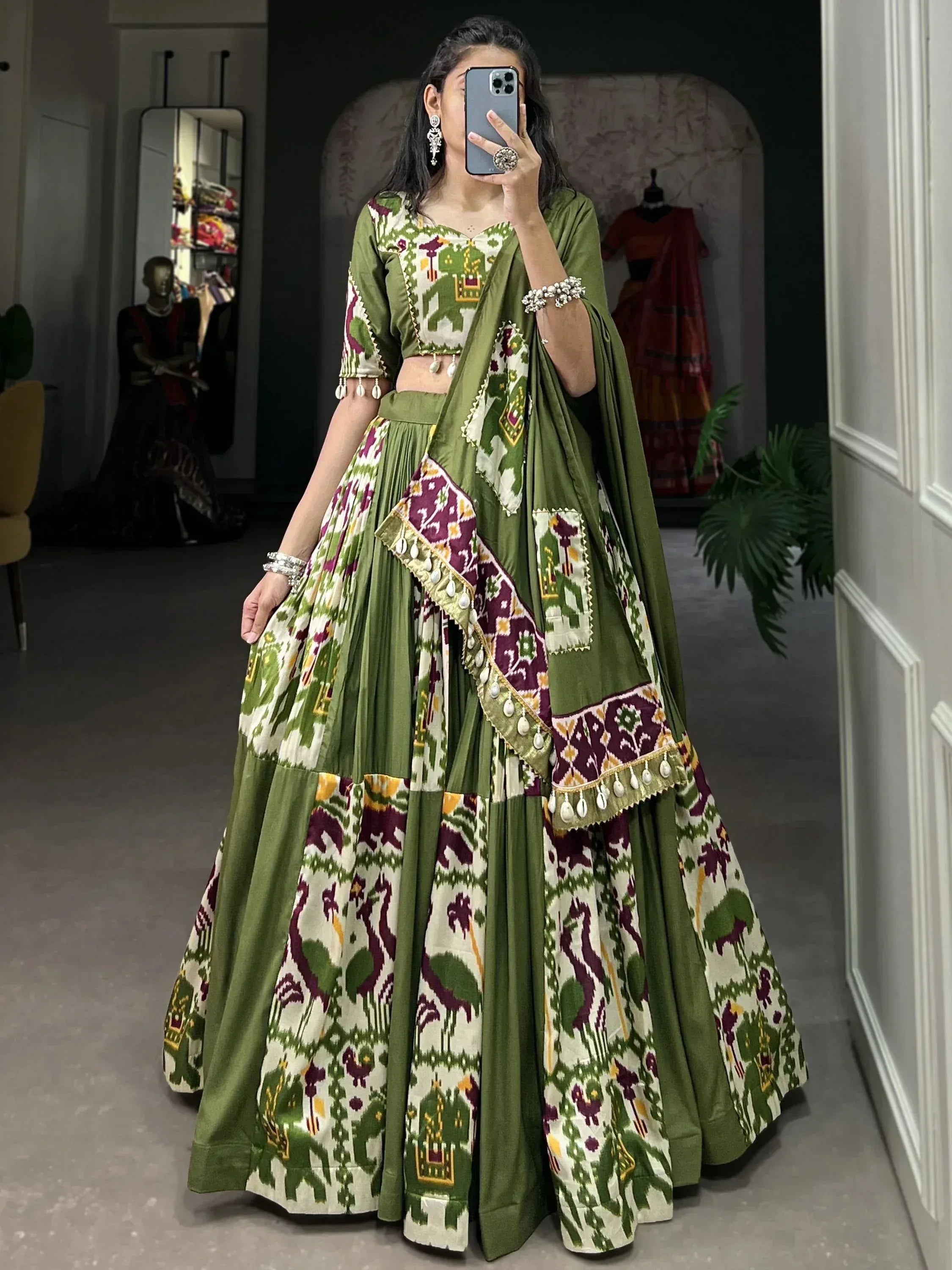 Green and purple printed lehenga choli with elephant motifs, perfect for Indian ethnic wear occasions.