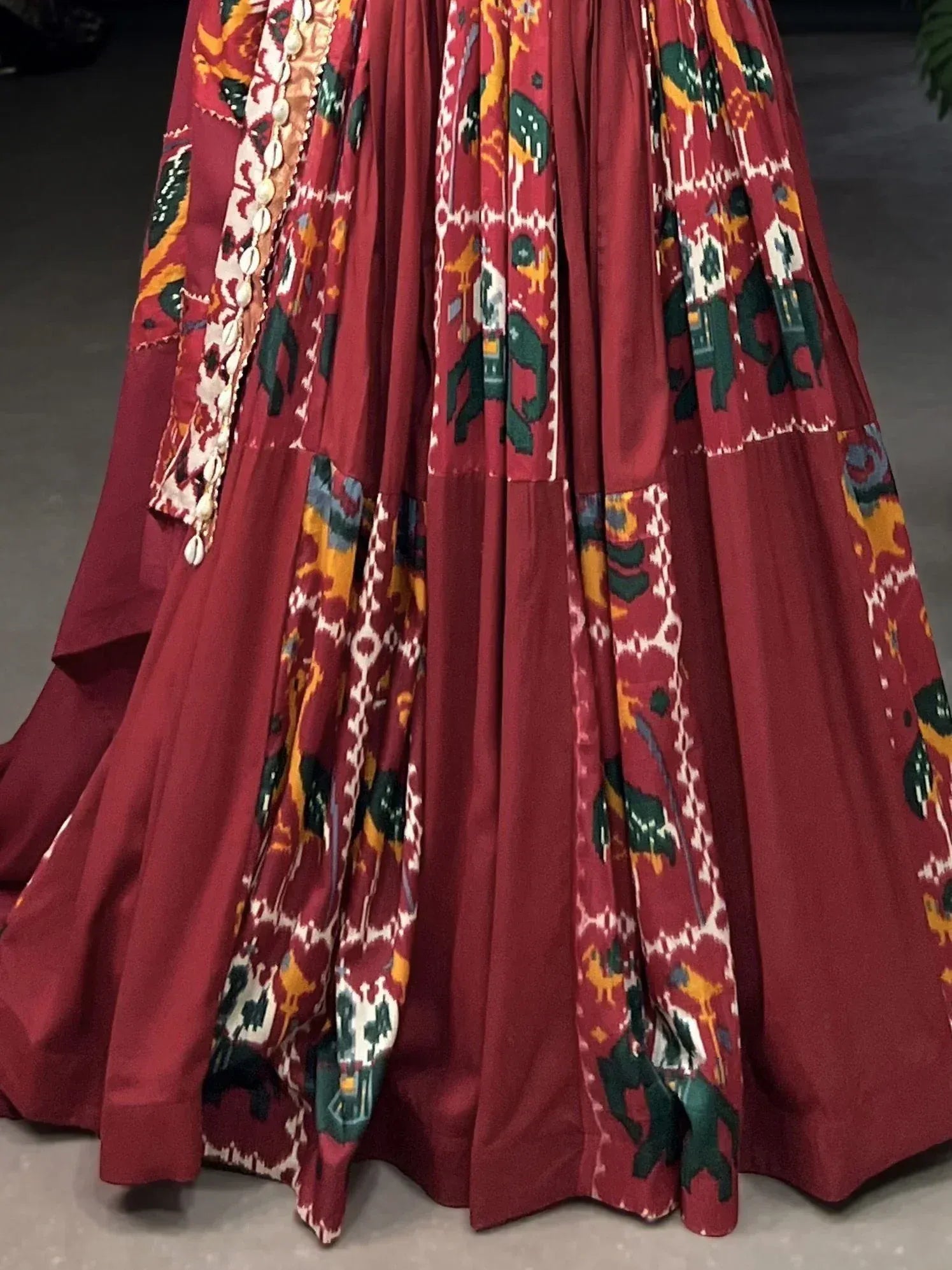 Red ethnic gown with elephant print and shell embellishments, perfect for Indian festive wear