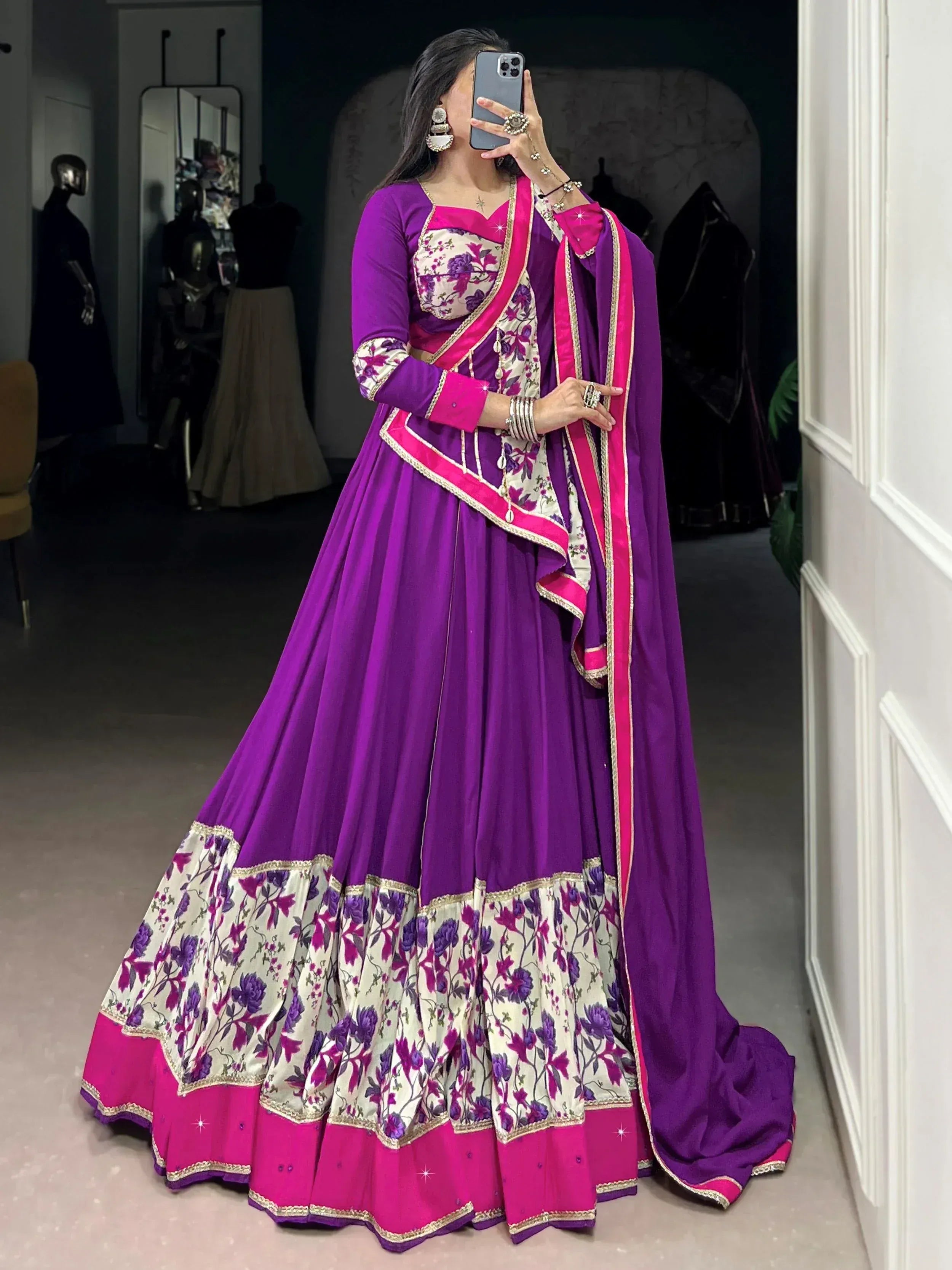 Purple and pink floral lehenga choli with gold trim, perfect for Indian weddings and festive occasions.