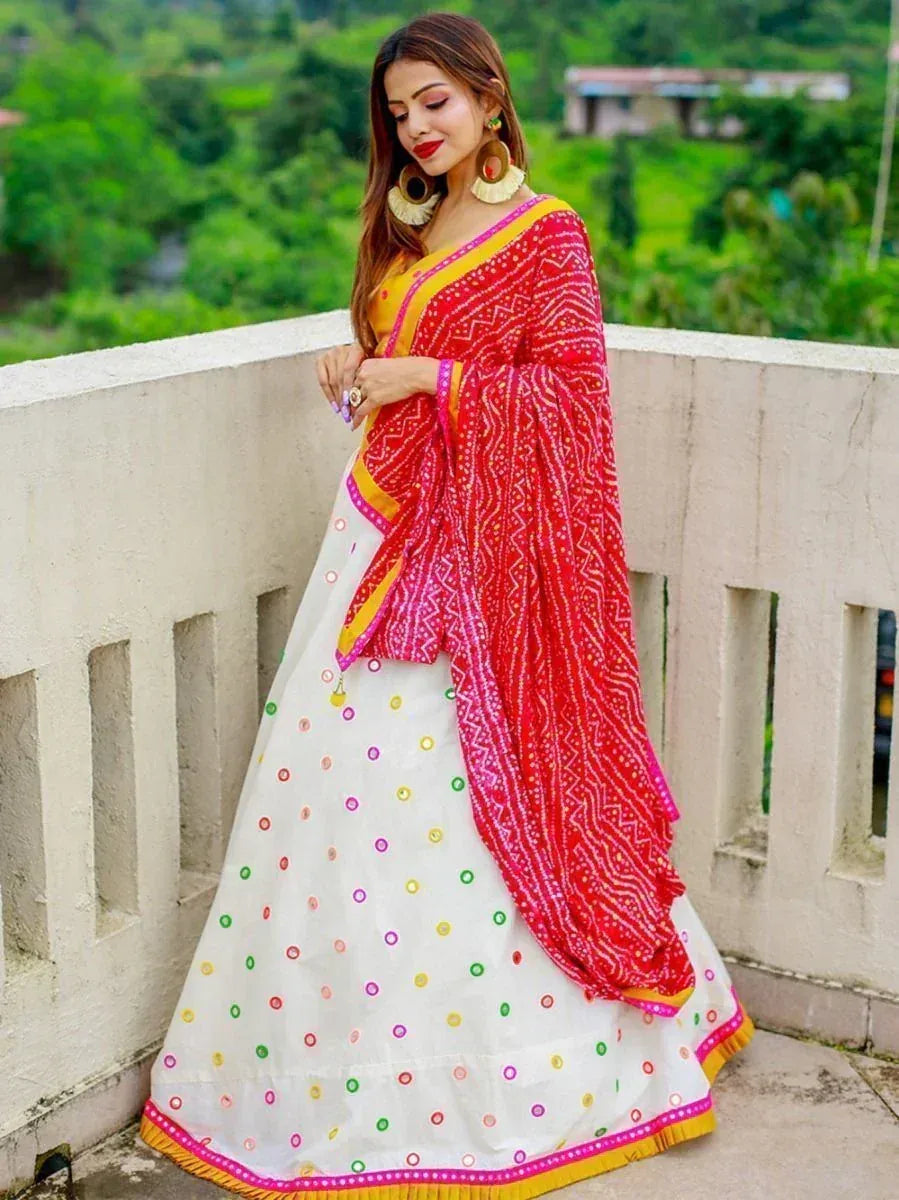 Woman in white lehenga with colorful embroidery and red dupatta, ethnic Indian wear
