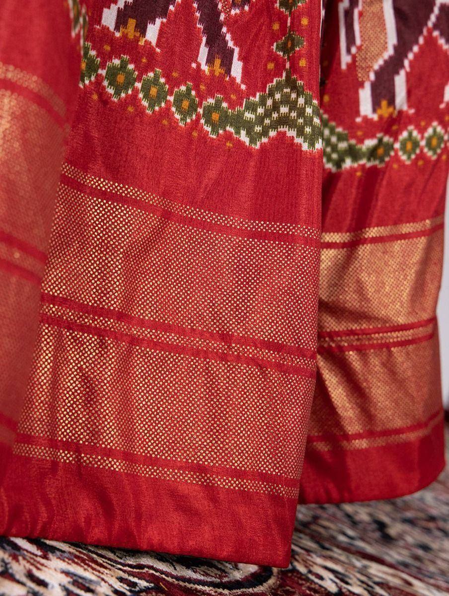 Red ethnic saree with geometric ikat print and gold zari border, traditional Indian wear