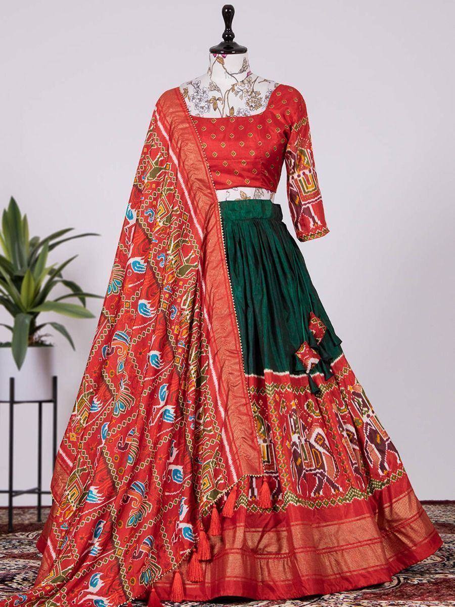 Red and green printed lehenga choli with elephant motifs and tassels, Indian ethnic wear
