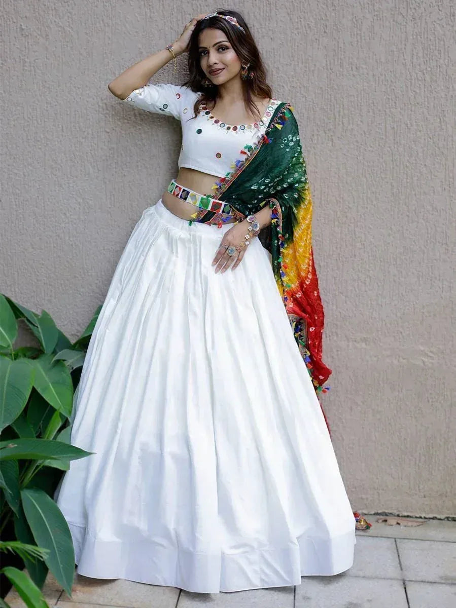 White lehenga choli with colorful mirror work and green-yellow dupatta, ethnic Indian wear