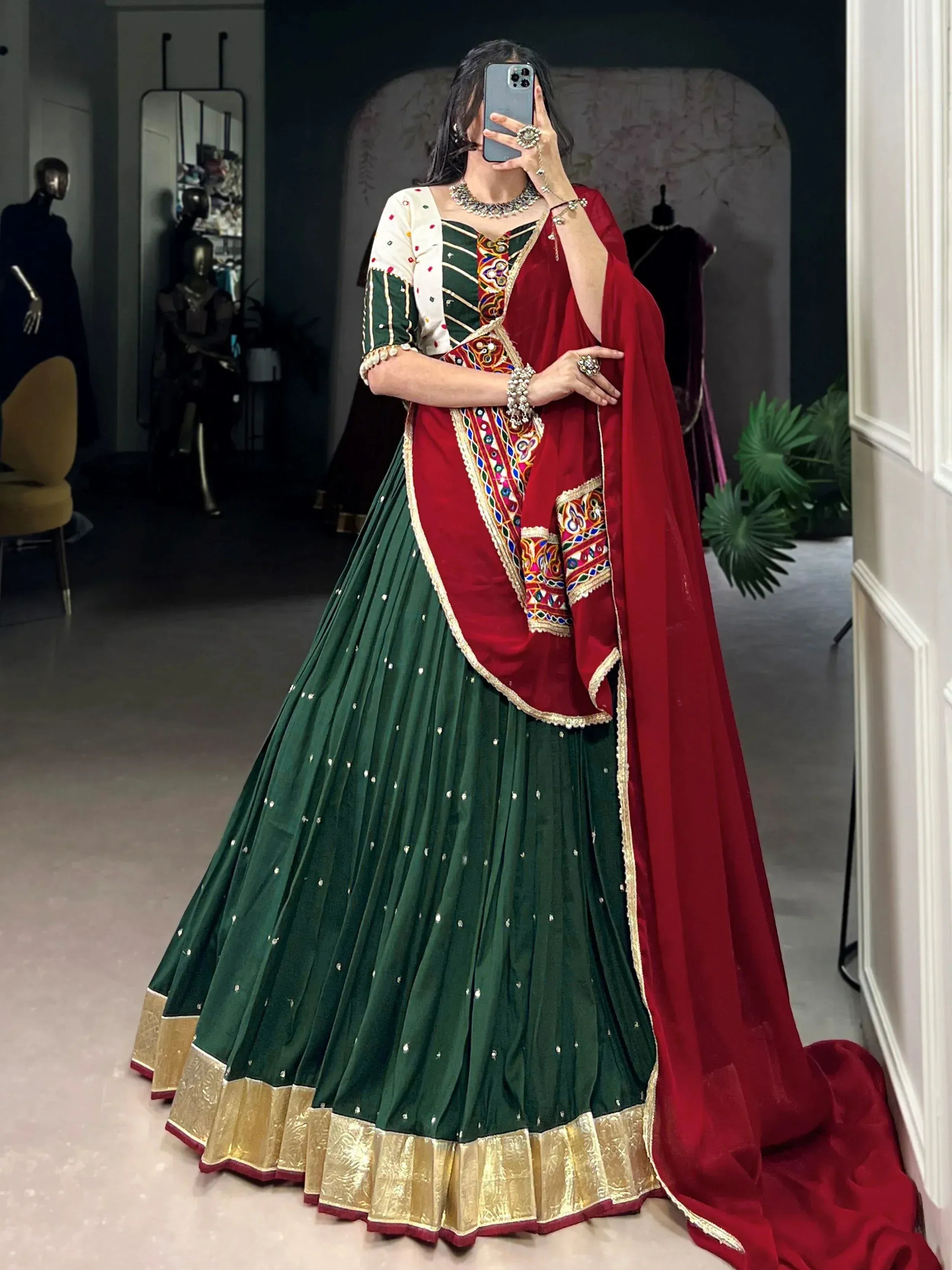 Green and red embroidered lehenga choli with gold border, perfect for Indian ethnic wear occasions