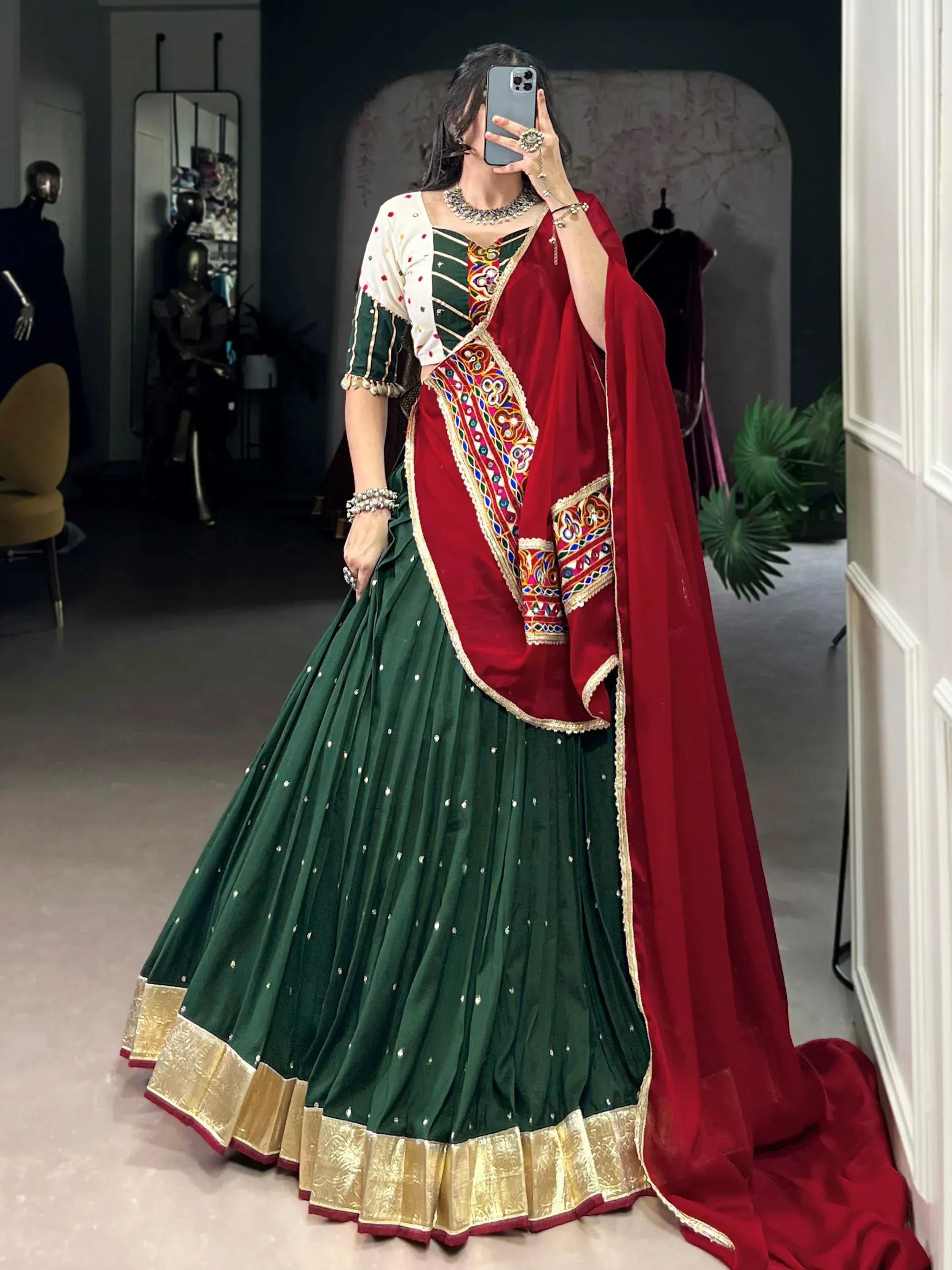 Green and red embroidered lehenga choli with mirror work, perfect for Indian ethnic wear and festive occasions.