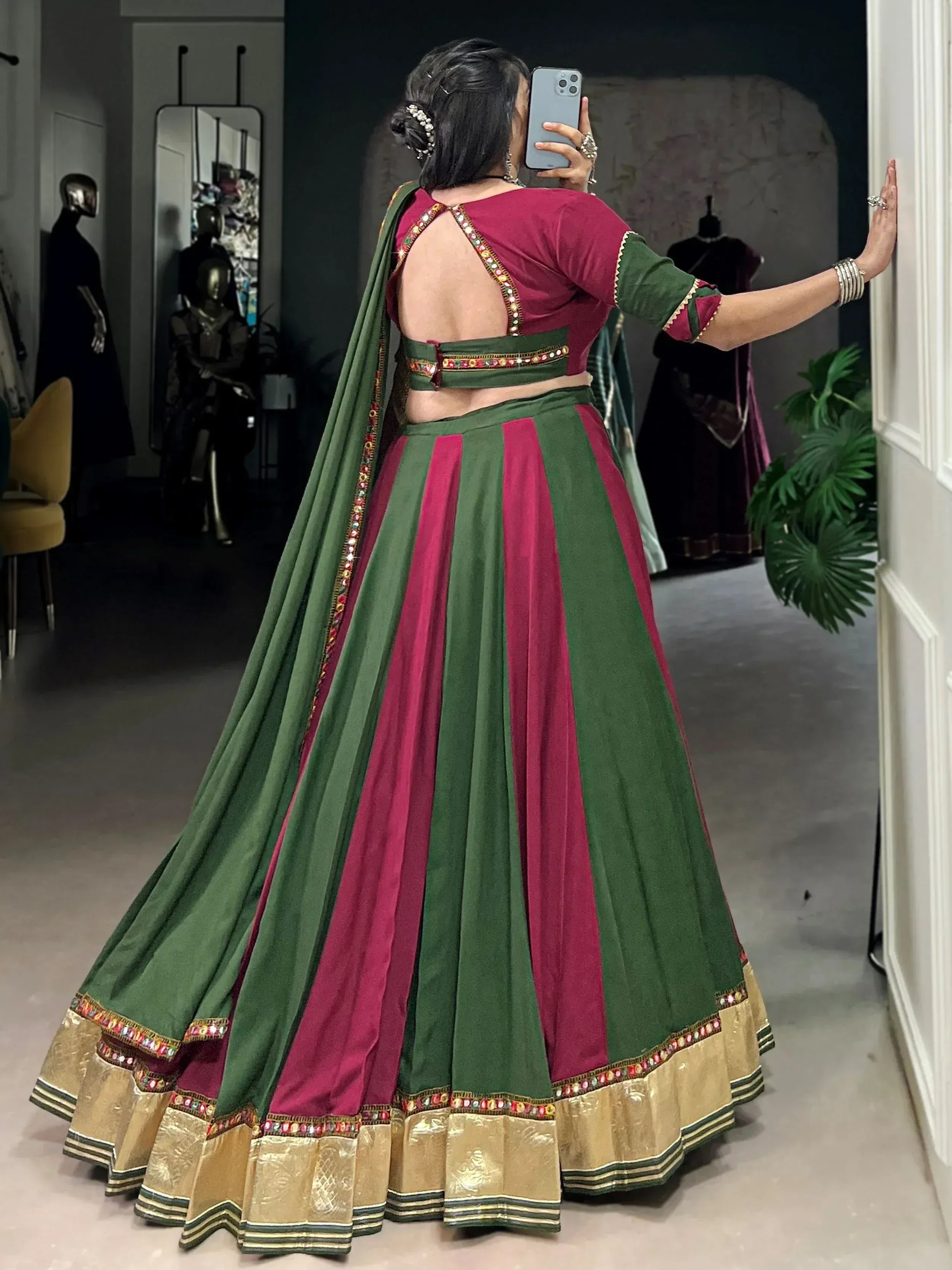 Green and maroon designer lehenga choli with mirror work, backless blouse, and gold border