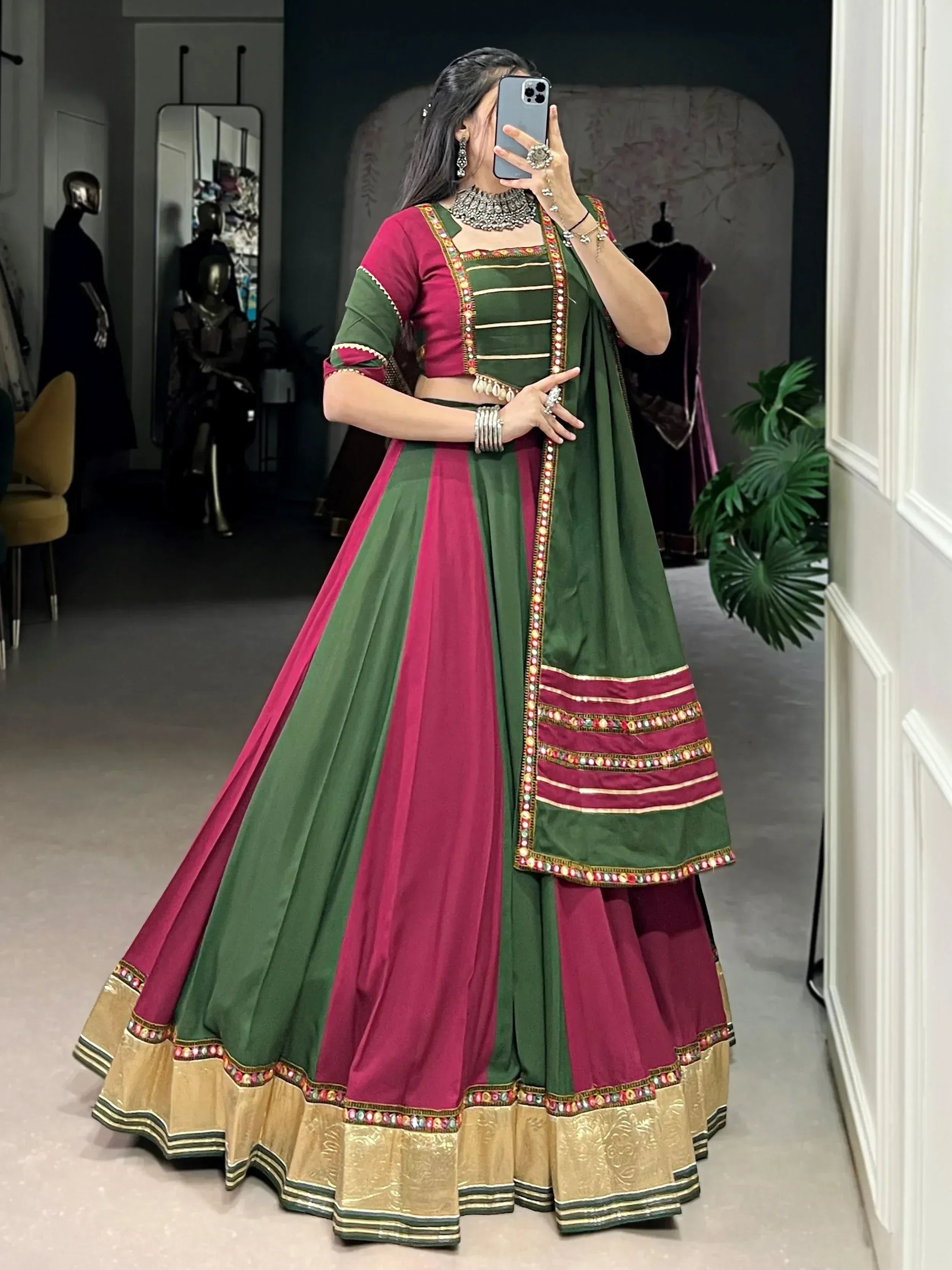 Green and pink embroidered lehenga choli with mirror work, perfect for Indian ethnic wear occasions