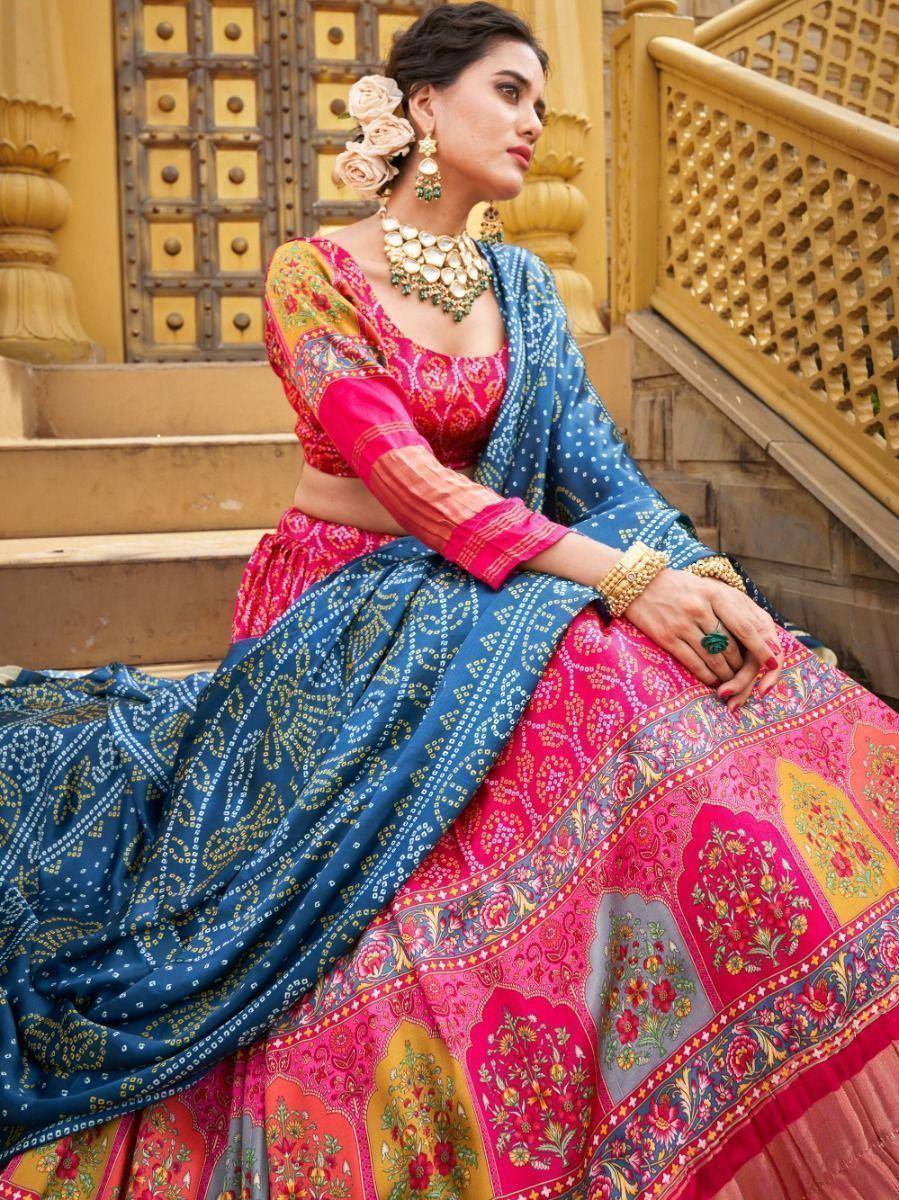 Vibrant pink and blue printed lehenga choli with ethnic jewelry, perfect for Indian weddings and festivals