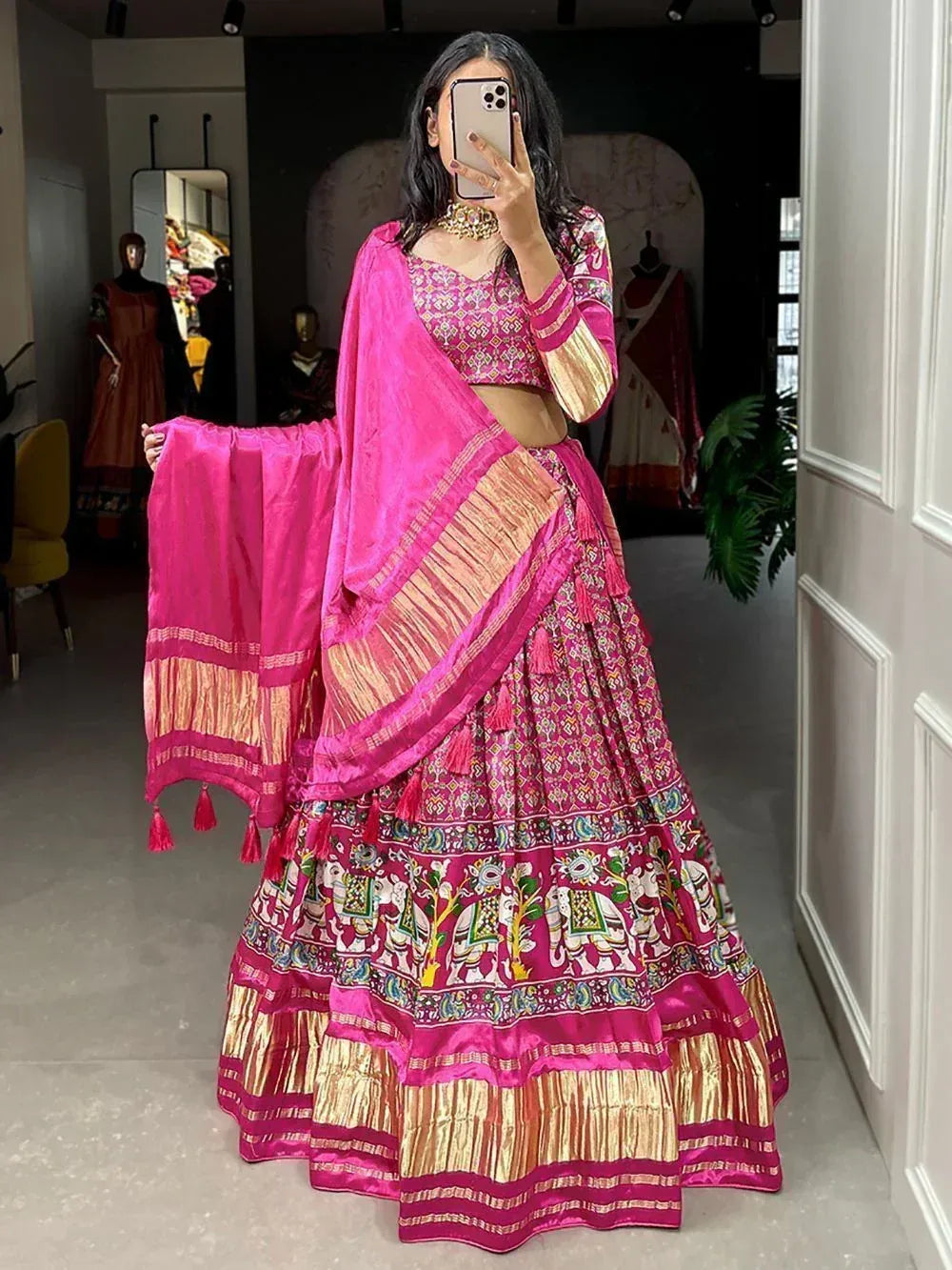 Pink embroidered lehenga choli with elephant print, gold border, and matching dupatta for Indian ethnic wear
