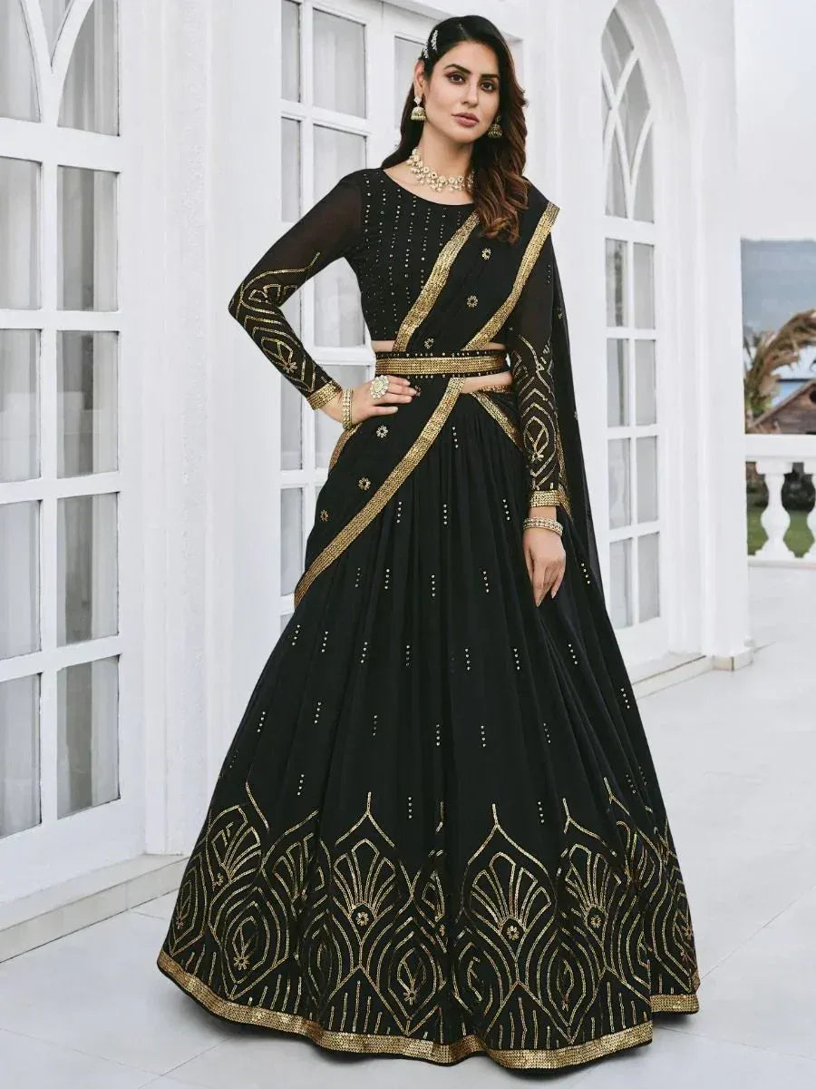 Black and gold embroidered lehenga choli with sheer sleeves, perfect for Indian ethnic wear events