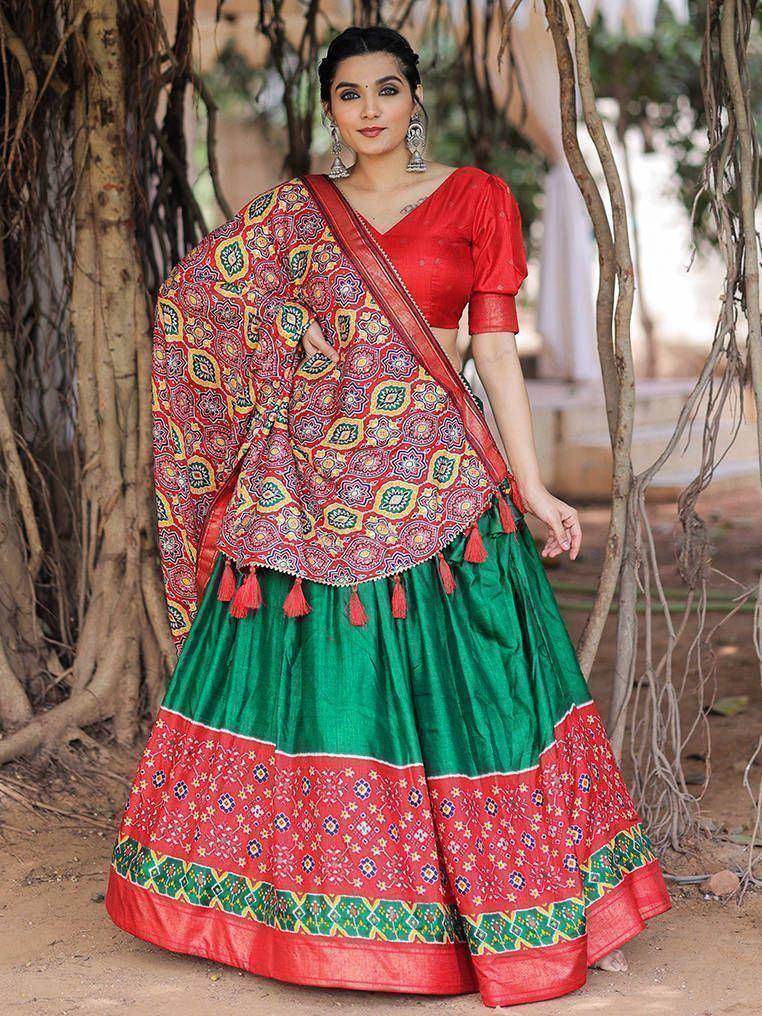 Vibrant red and green ethnic lehenga choli with floral dupatta, perfect for Indian celebrations