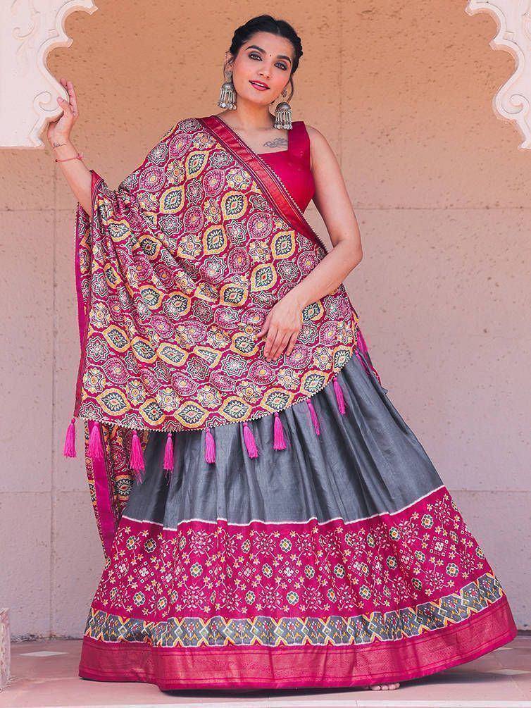 Woman in vibrant pink and grey lehenga choli with floral print and tassels, perfect for Indian ethnic wear
