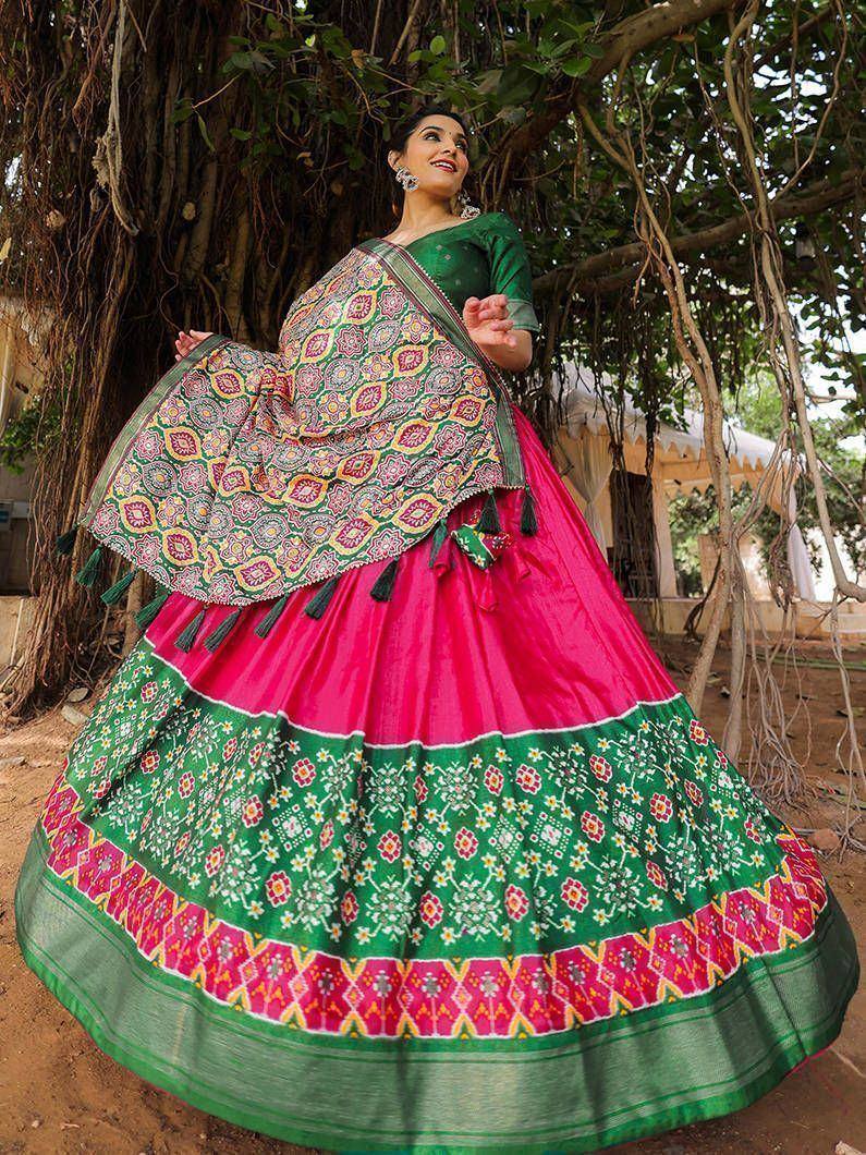 Vibrant pink and green ethnic lehenga choli with floral print and dupatta, perfect for Indian weddings and festivals