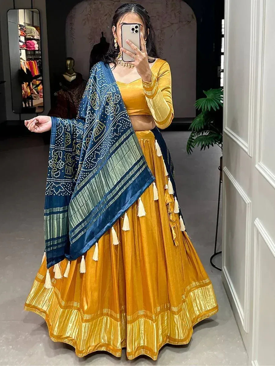 Mustard yellow lehenga choli with blue printed dupatta, tassels, and velvet top for Indian ethnic wear