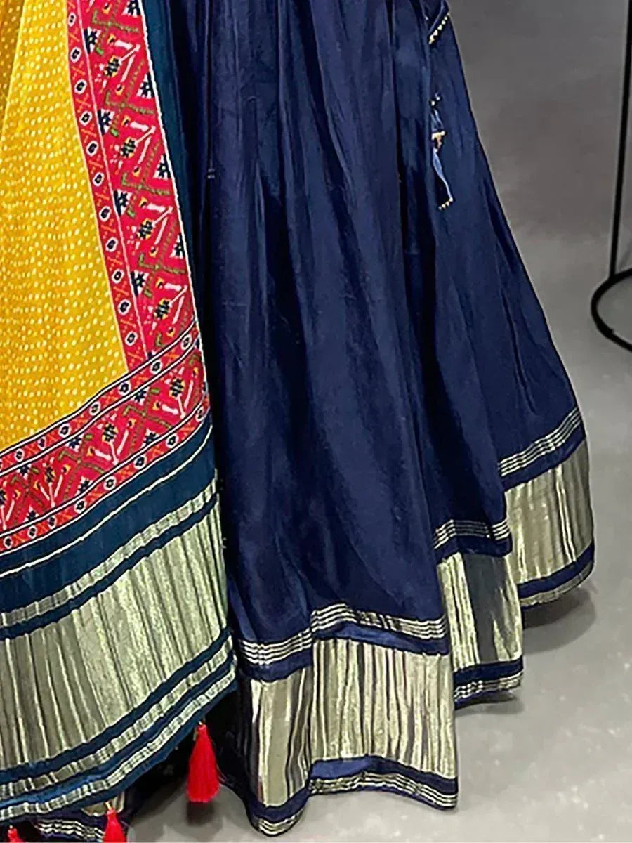 Navy blue and yellow ethnic lehenga with embroidered border and gold pleated hem, perfect for festive occasions.