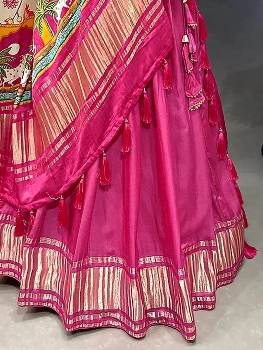 Vibrant pink ethnic lehenga with gold stripes and tassels, perfect for Indian weddings and festive occasions.