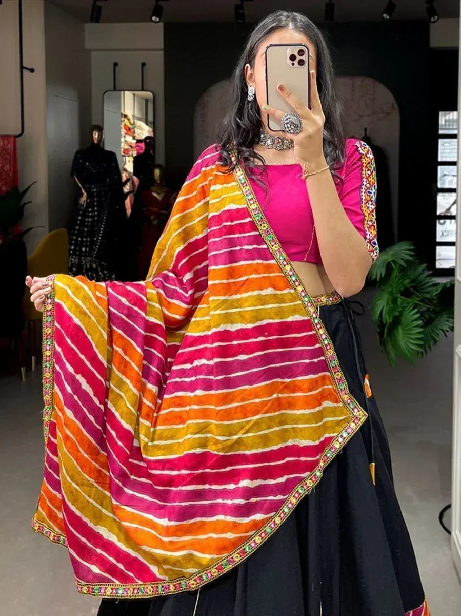 Woman wearing vibrant striped dupatta with pink blouse and black skirt, showcasing Indian ethnic wear