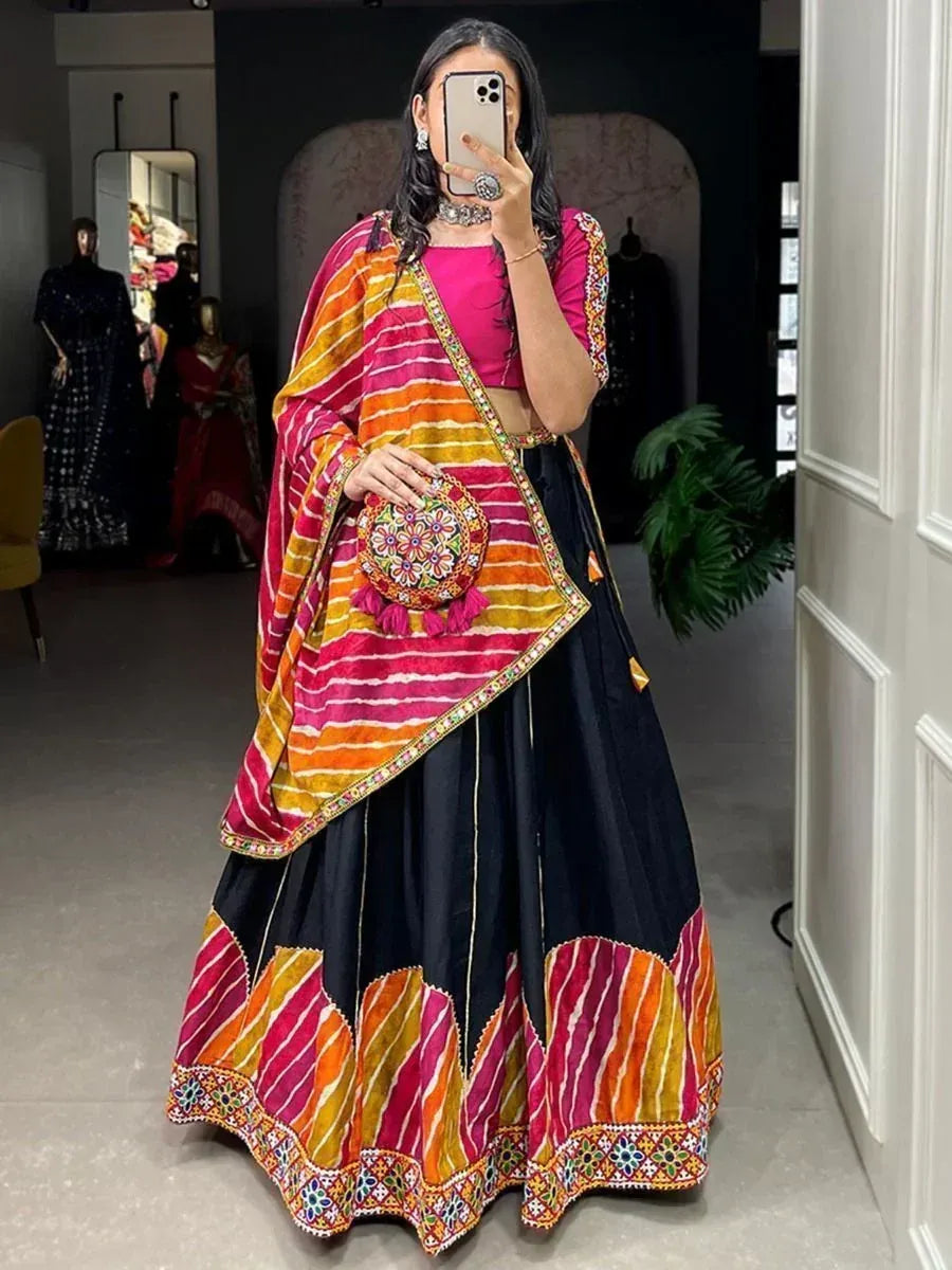 Vibrant pink and black lehenga choli with striped dupatta, perfect for Indian ethnic occasions
