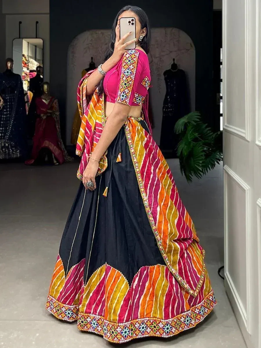 Vibrant pink and black lehenga choli with colorful striped dupatta, perfect for Indian ethnic wear occasions.