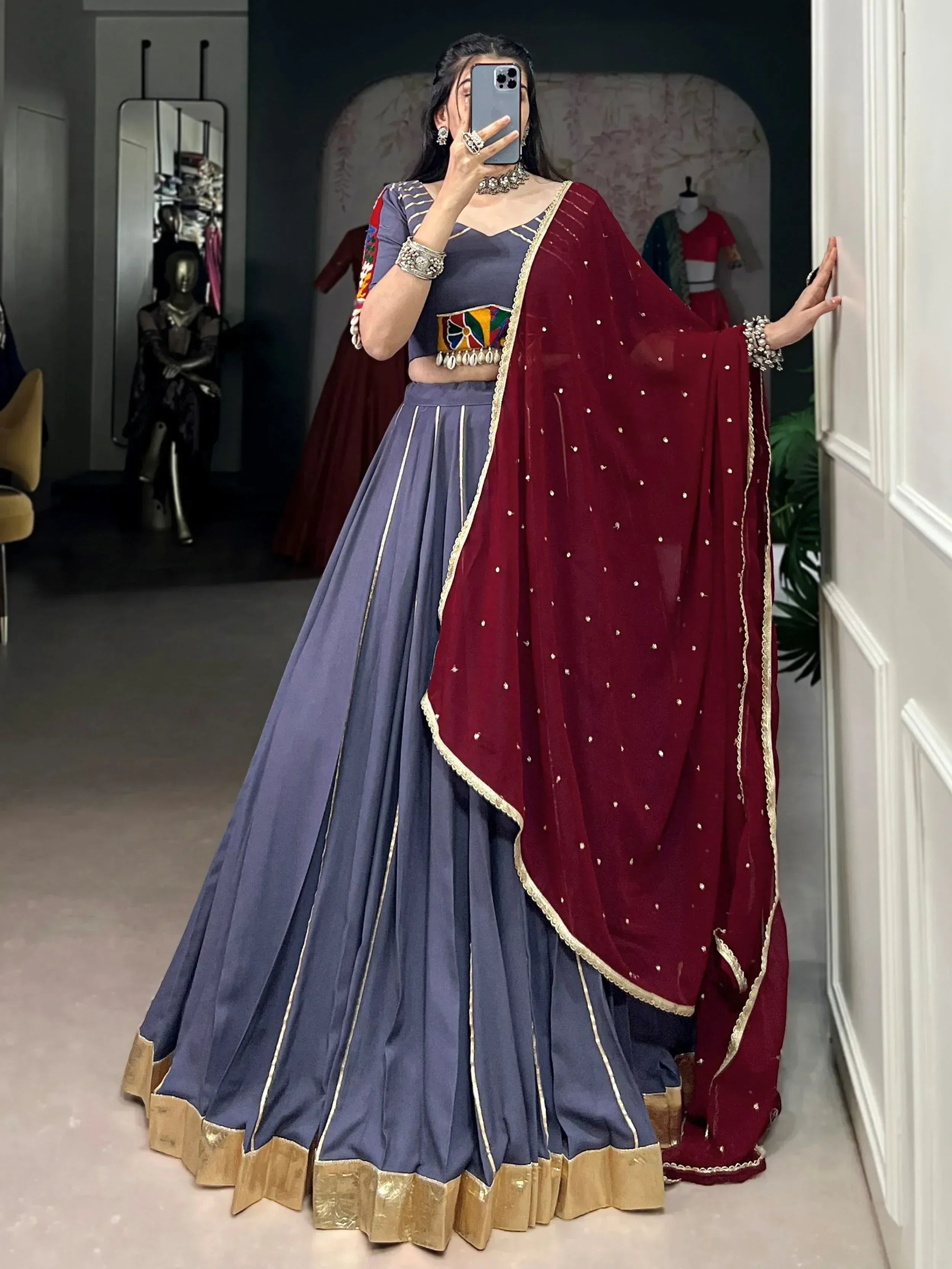 Blue lehenga choli with maroon dupatta, gold trim, and colorful embroidery for Indian ethnic wear