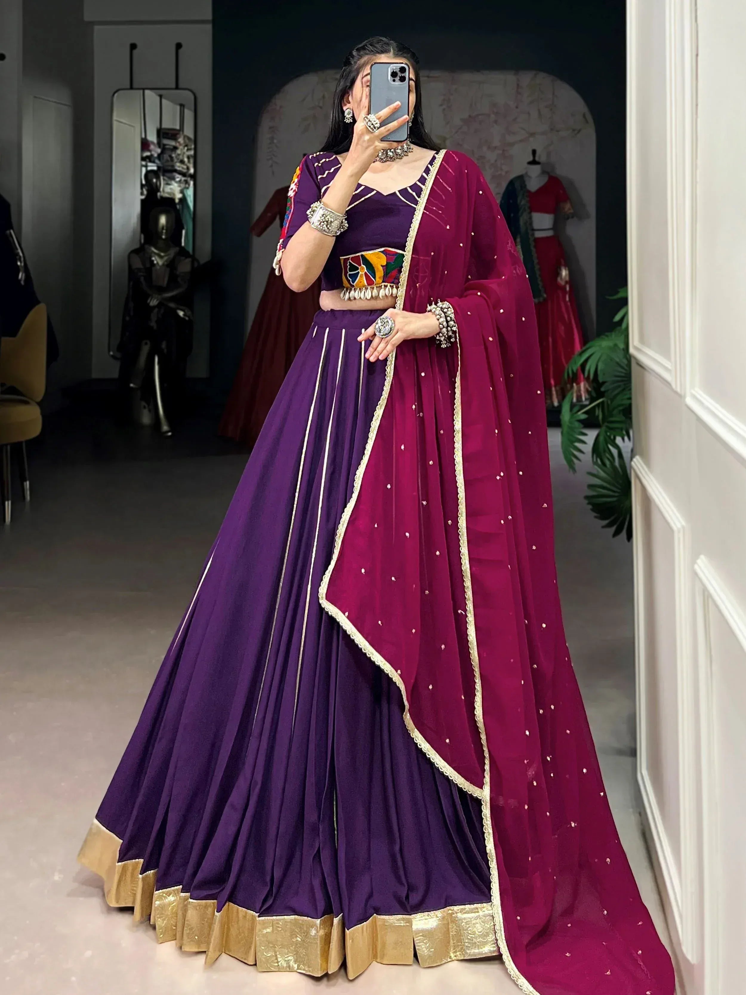 Purple and maroon designer lehenga choli with gold trim and embroidered dupatta, perfect for Indian ethnic wear occasions