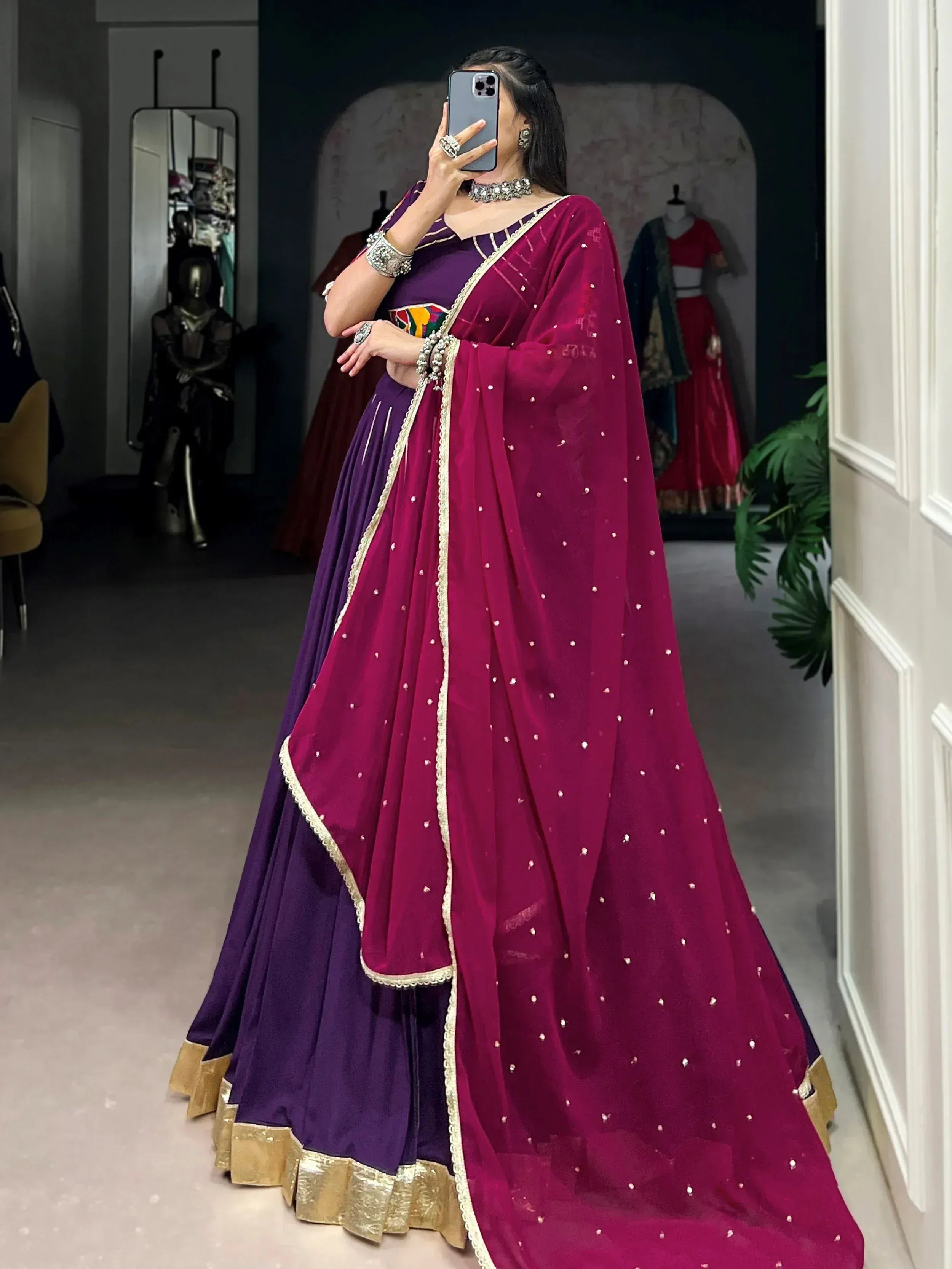 Purple and magenta designer lehenga choli with gold trim and embellished dupatta, perfect for Indian ethnic wear.