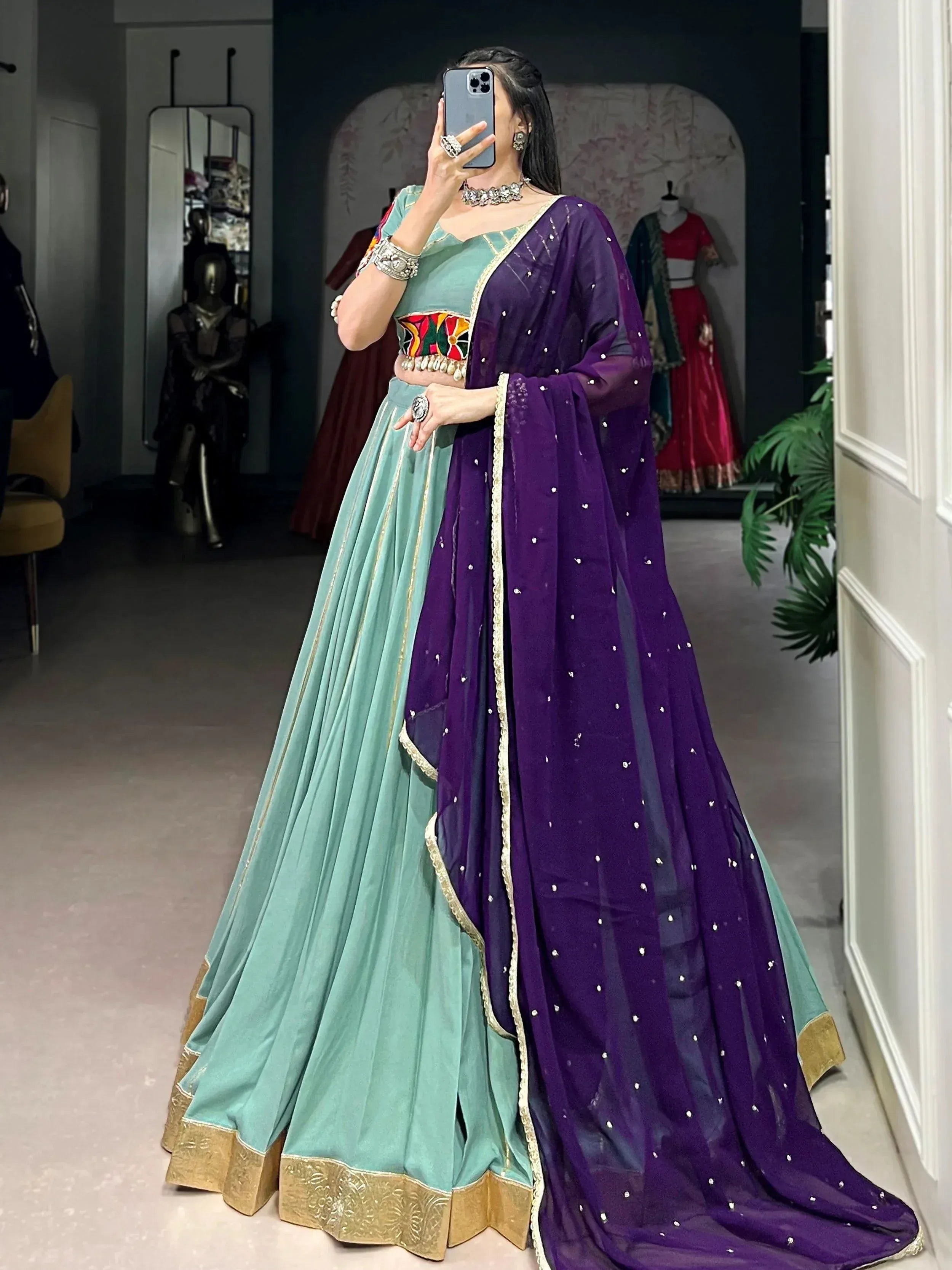 Elegant teal and purple lehenga choli with gold embroidery and sequins, perfect for Indian ethnic wear.