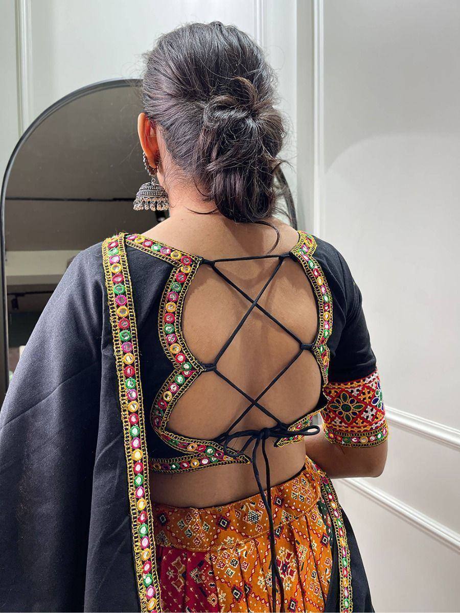 Black embroidered blouse with crisscross back tie, paired with colorful lehenga, Indian ethnic wear