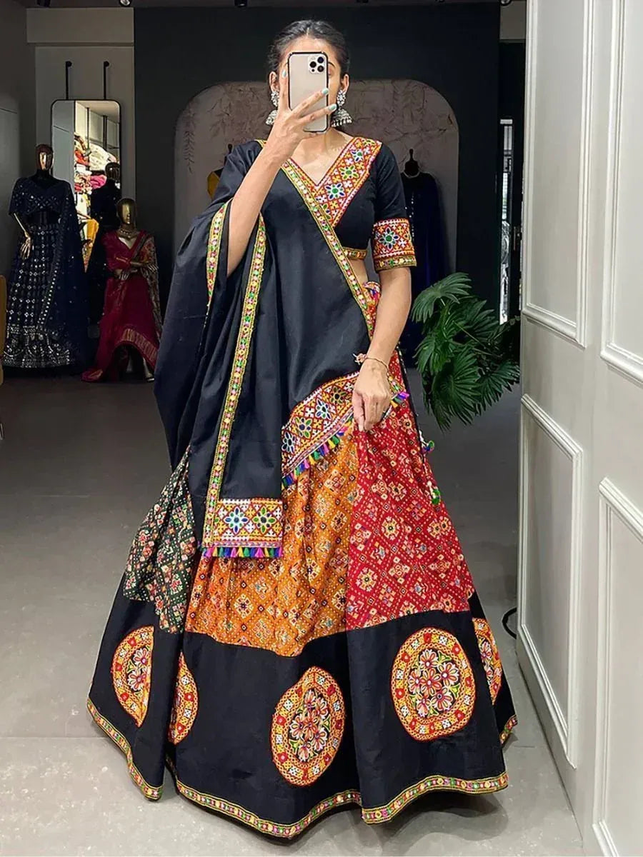 Black and red embroidered lehenga choli with colorful mirror work, perfect for Indian ethnic wear occasions.