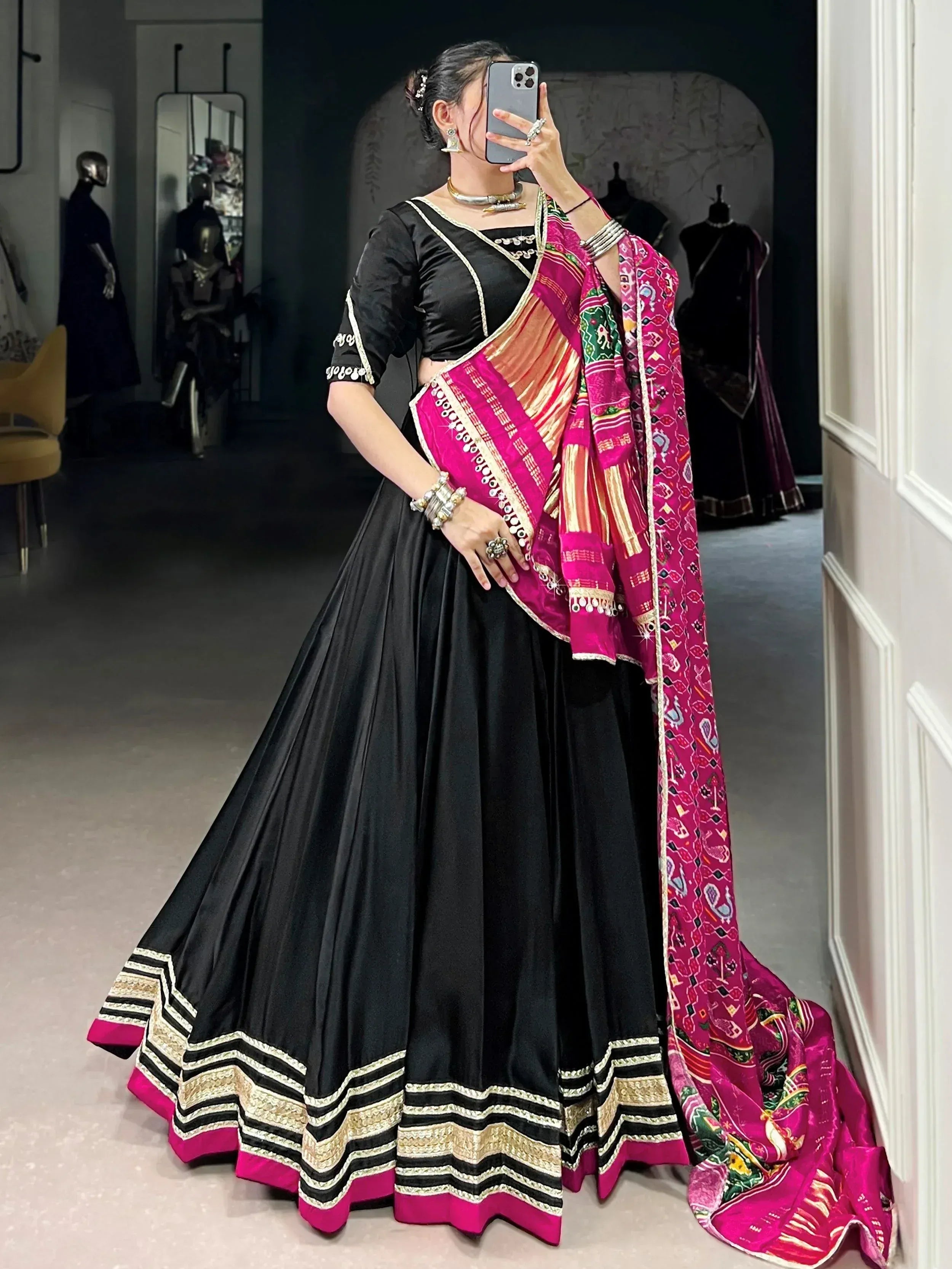 Black lehenga choli with vibrant pink dupatta, ethnic Indian wear for women