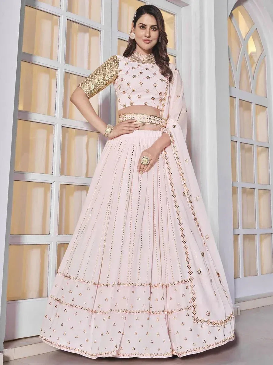 Pink designer lehenga choli with gold embroidery, perfect for weddings and festive occasions