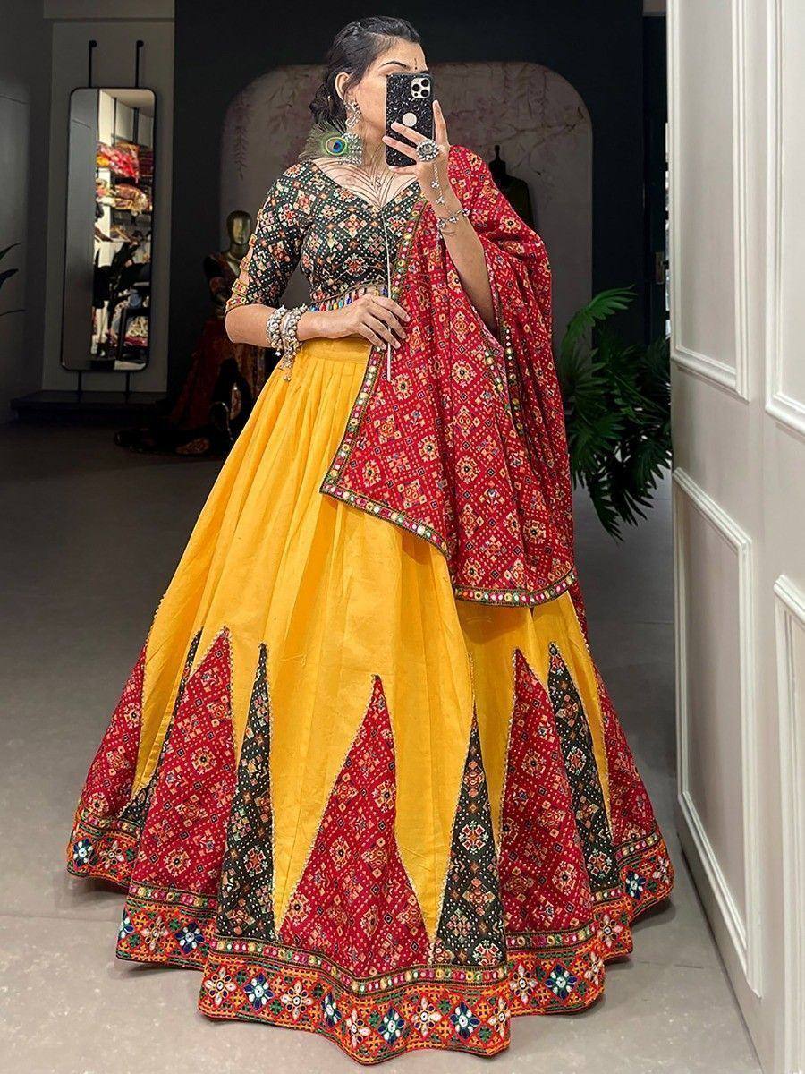 Vibrant yellow and red embroidered lehenga choli with mirror work, perfect for Indian ethnic occasions.