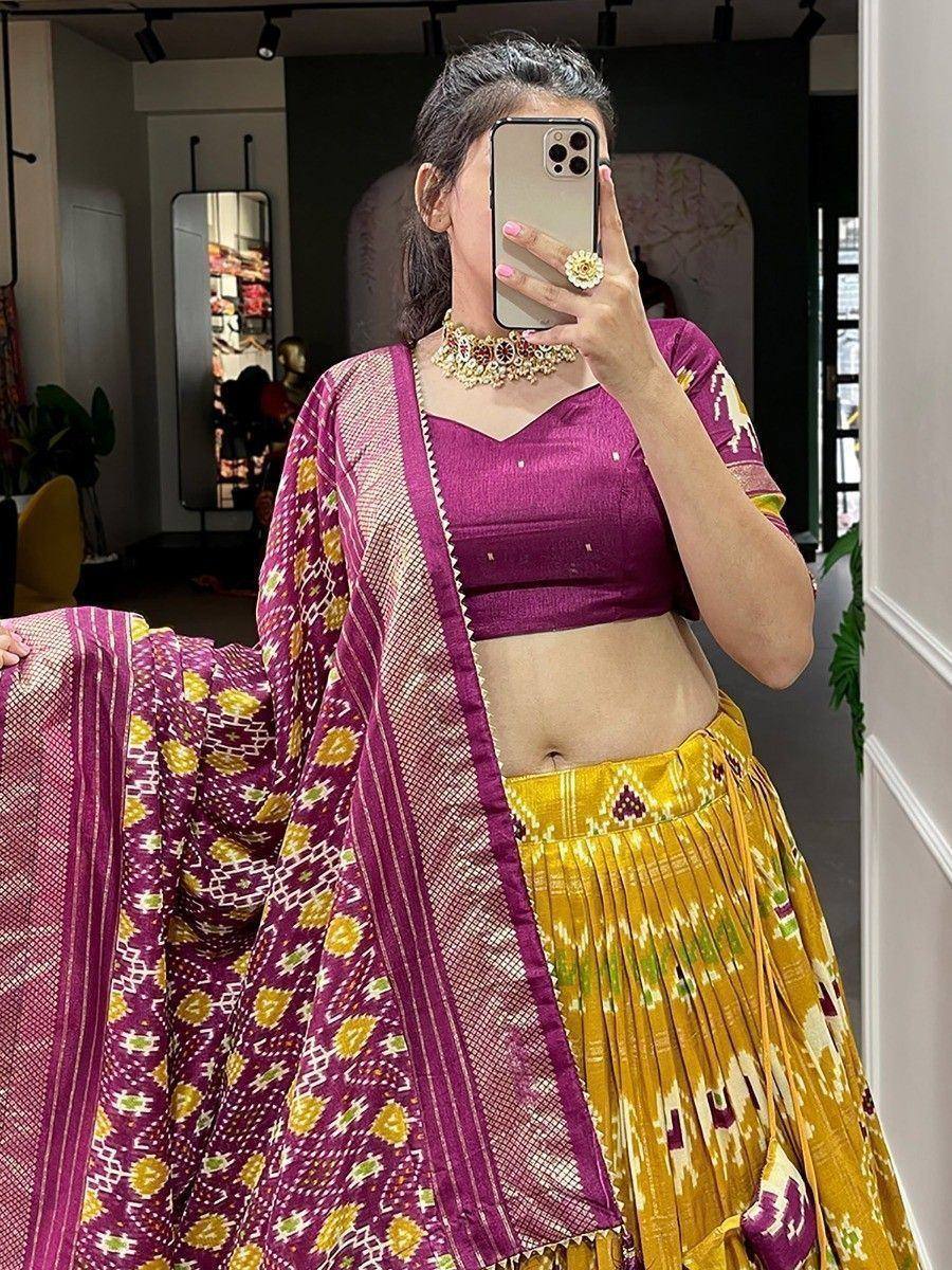 Woman in purple and yellow Ikat lehenga choli with matching dupatta, ethnic wear for festive occasions
