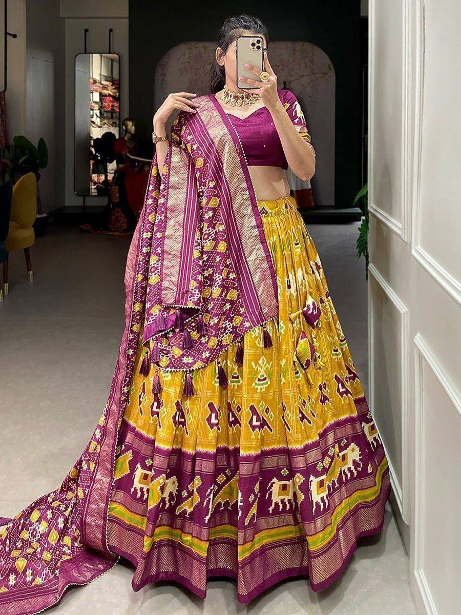 Vibrant yellow and purple Ikat lehenga choli with elephant motifs, perfect for Indian ethnic occasions