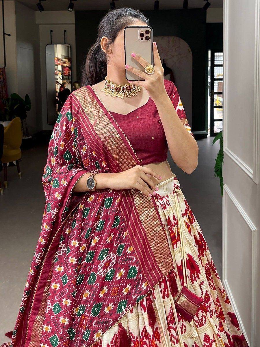 Maroon and cream ikat print lehenga choli with ethnic jewelry, perfect for Indian weddings and festive occasions