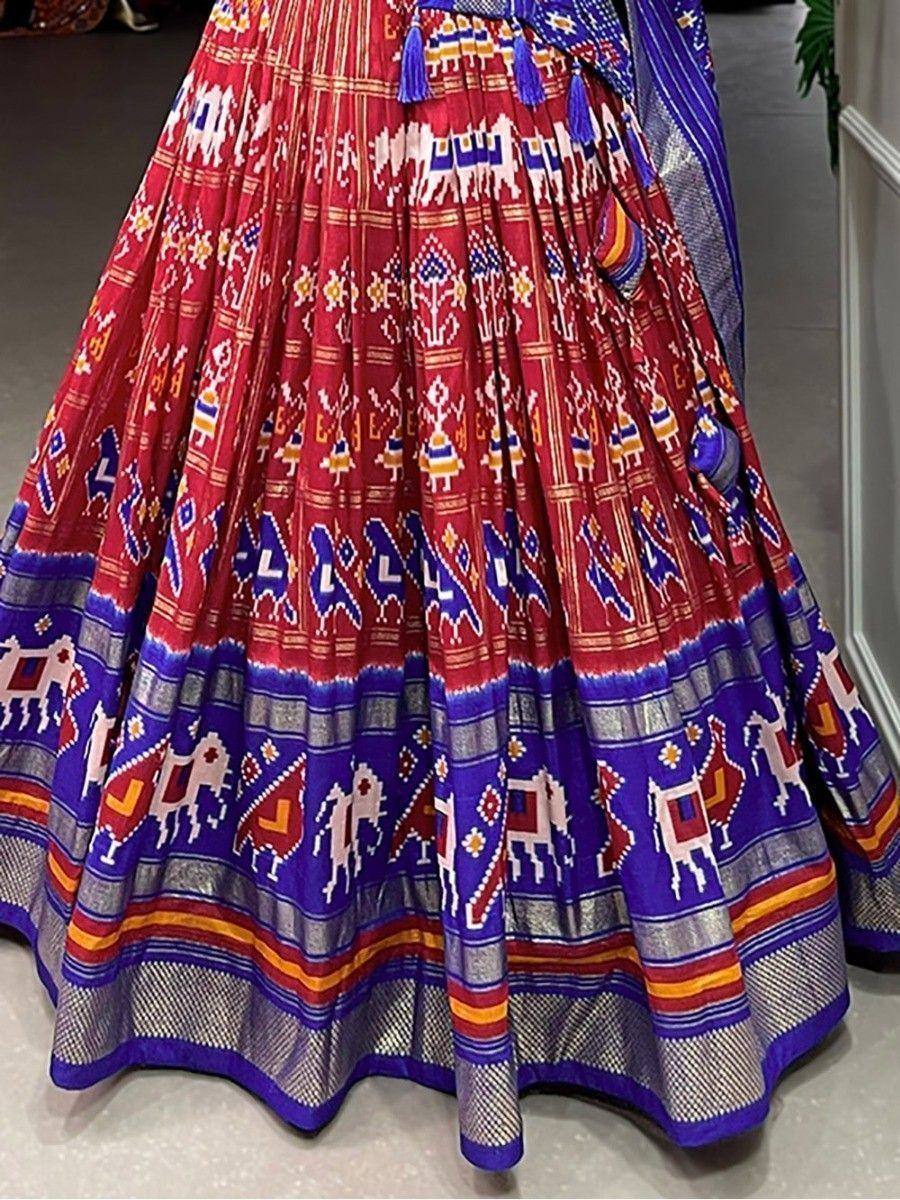 Vibrant red and blue ethnic lehenga with elephant motifs and tassels, perfect for Indian celebrations