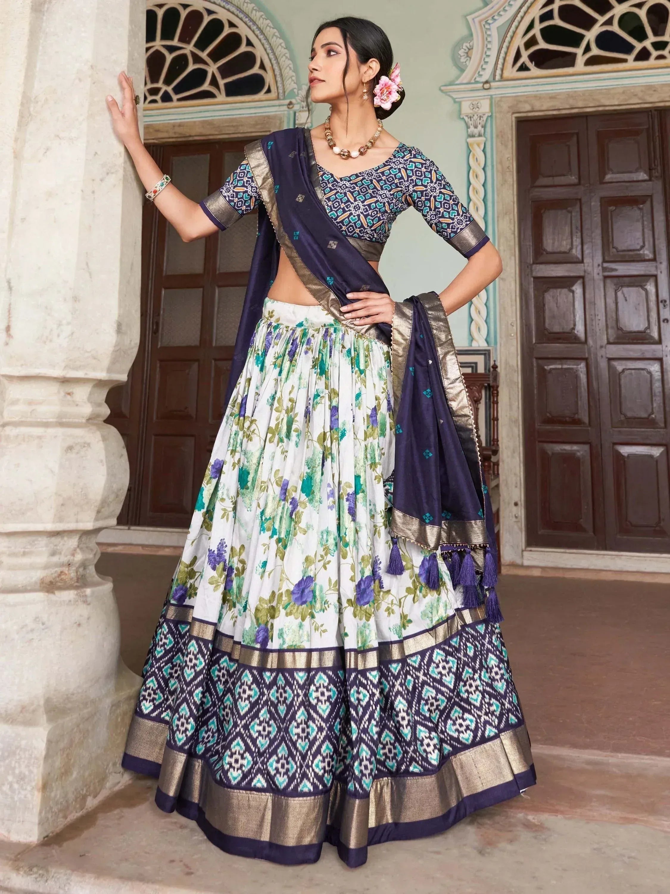 Woman in floral lehenga choli with navy dupatta, ethnic Indian wear for festive occasions