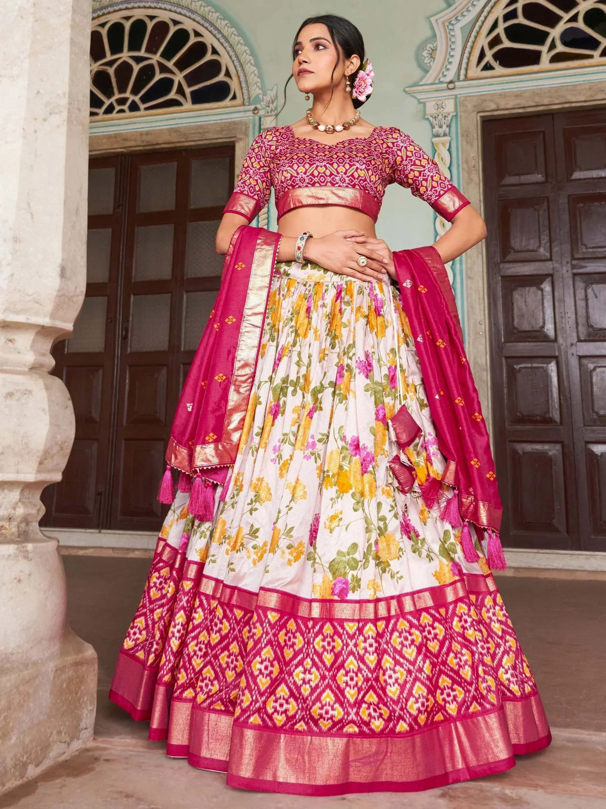 Woman in floral print lehenga choli with pink dupatta, traditional Indian ethnic wear for weddings and festivals
