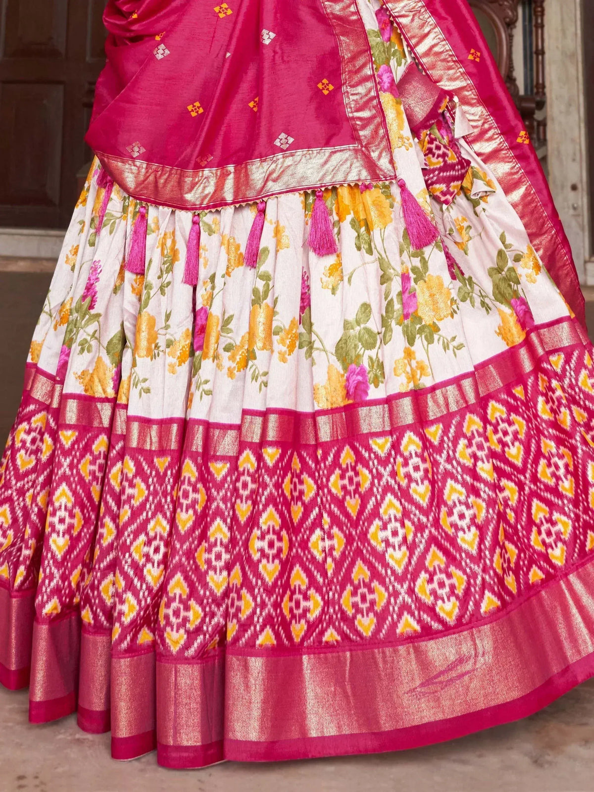 Pink and white floral lehenga with ikat border and tassels, ethnic Indian wear