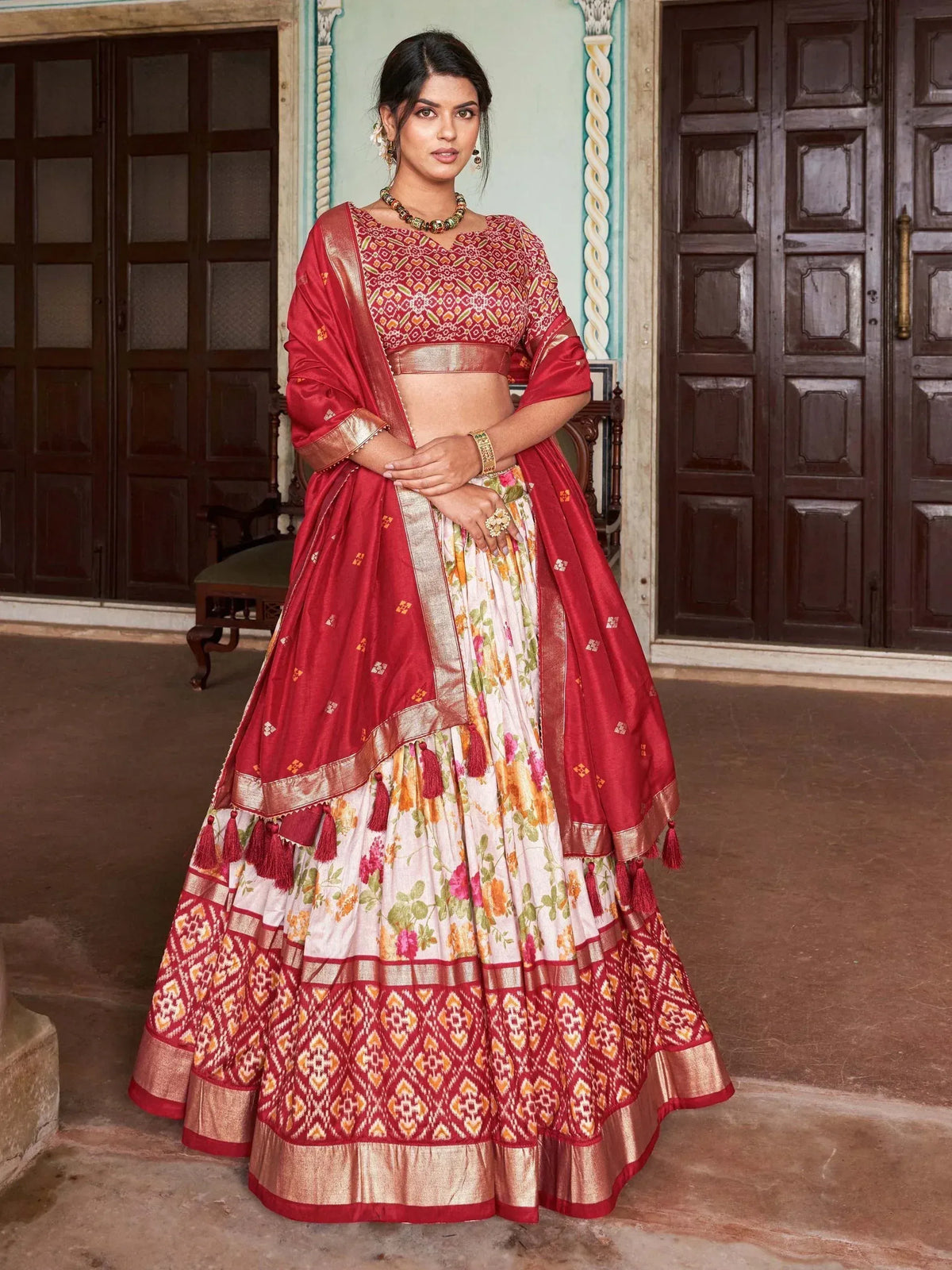 Red and white floral lehenga choli with gold embroidery and tassels, traditional Indian ethnic wear
