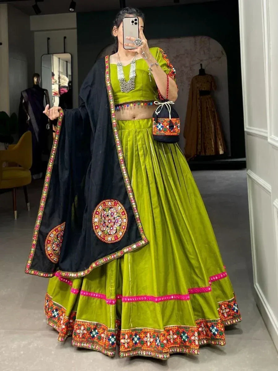 Vibrant green lehenga choli with black dupatta, colorful embroidery, and mirror work for festive occasions