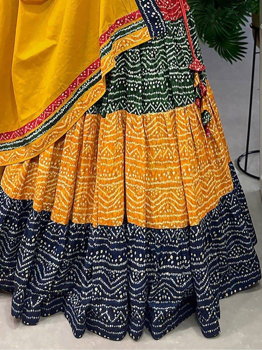 Vibrant yellow and navy blue printed lehenga choli with intricate geometric patterns and pleated skirt