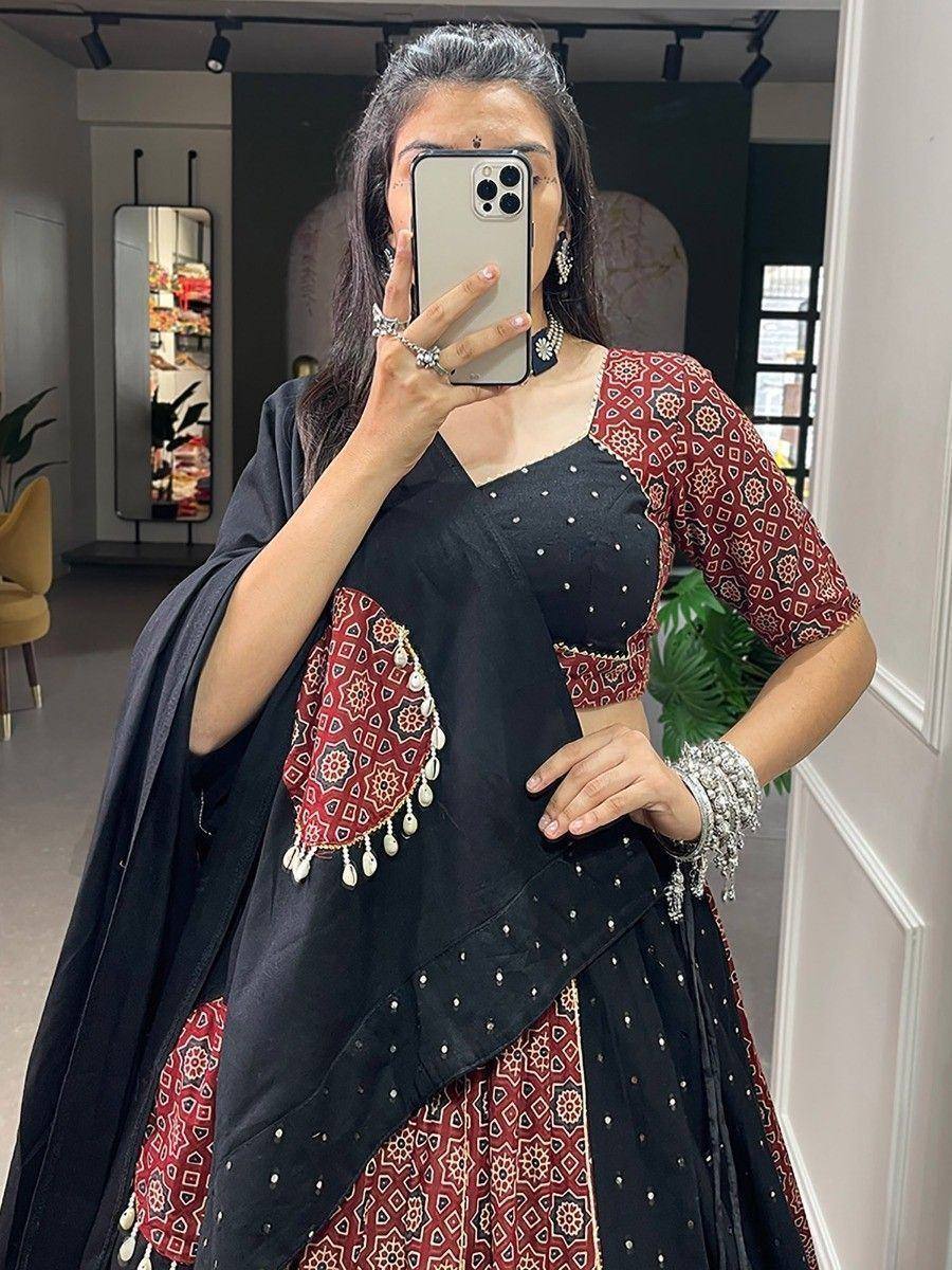 Black and red ethnic lehenga choli with mirror work and dupatta, perfect for Indian weddings or festive occasions.