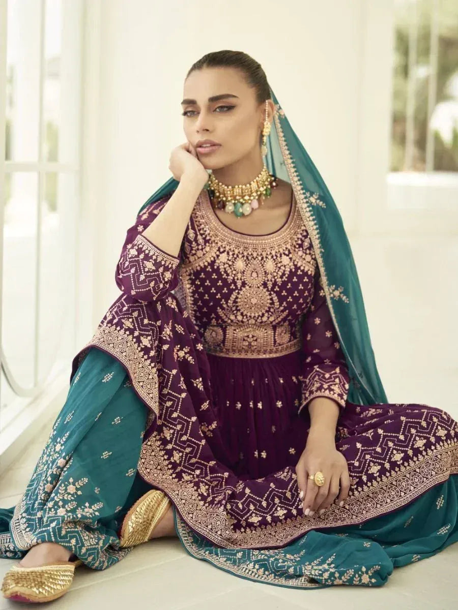 Woman in designer purple and teal embroidered salwar kameez with dupatta, traditional jewelry