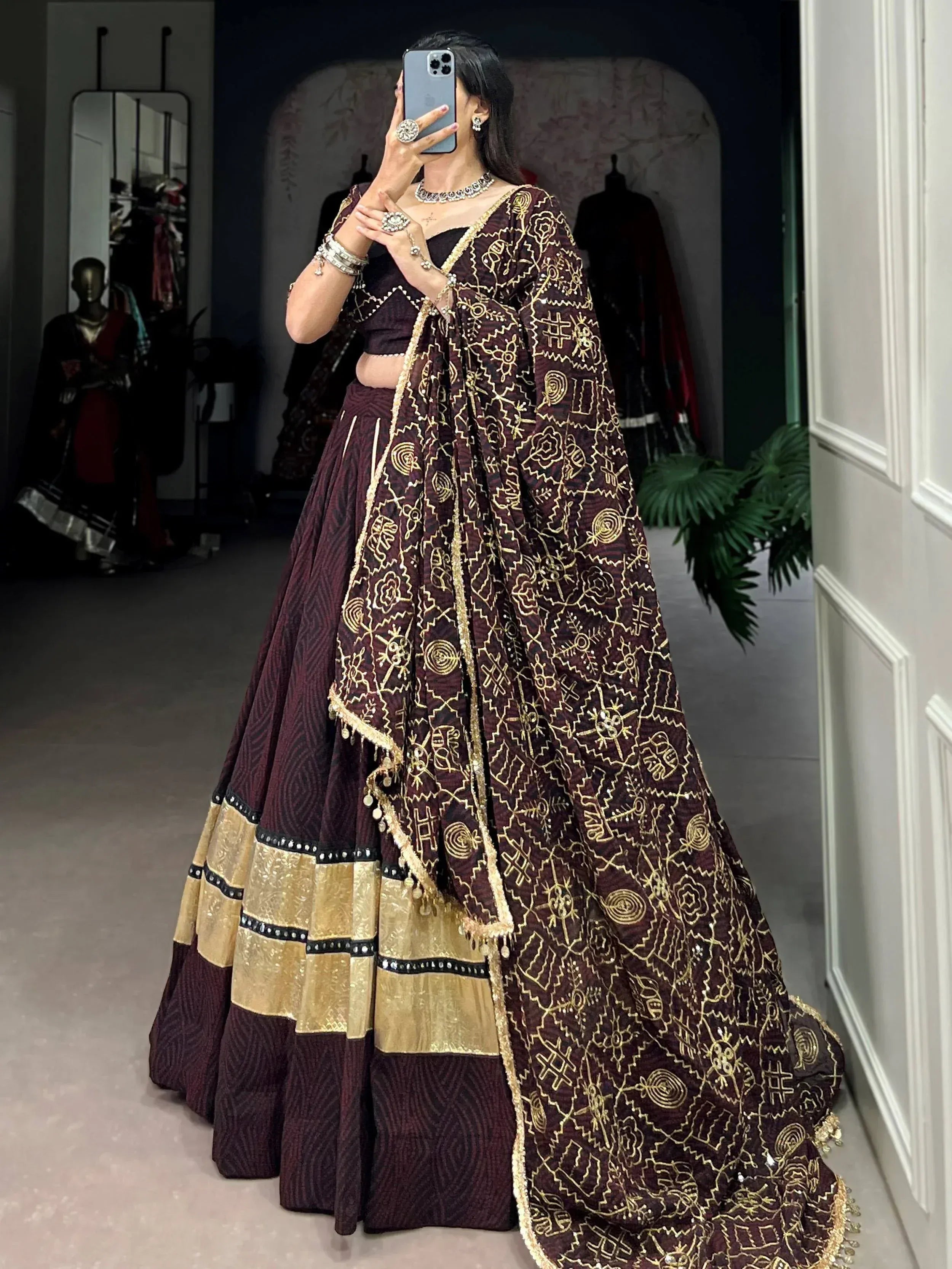Maroon and gold embroidered lehenga choli with intricate patterns, perfect for Indian ethnic wear occasions.