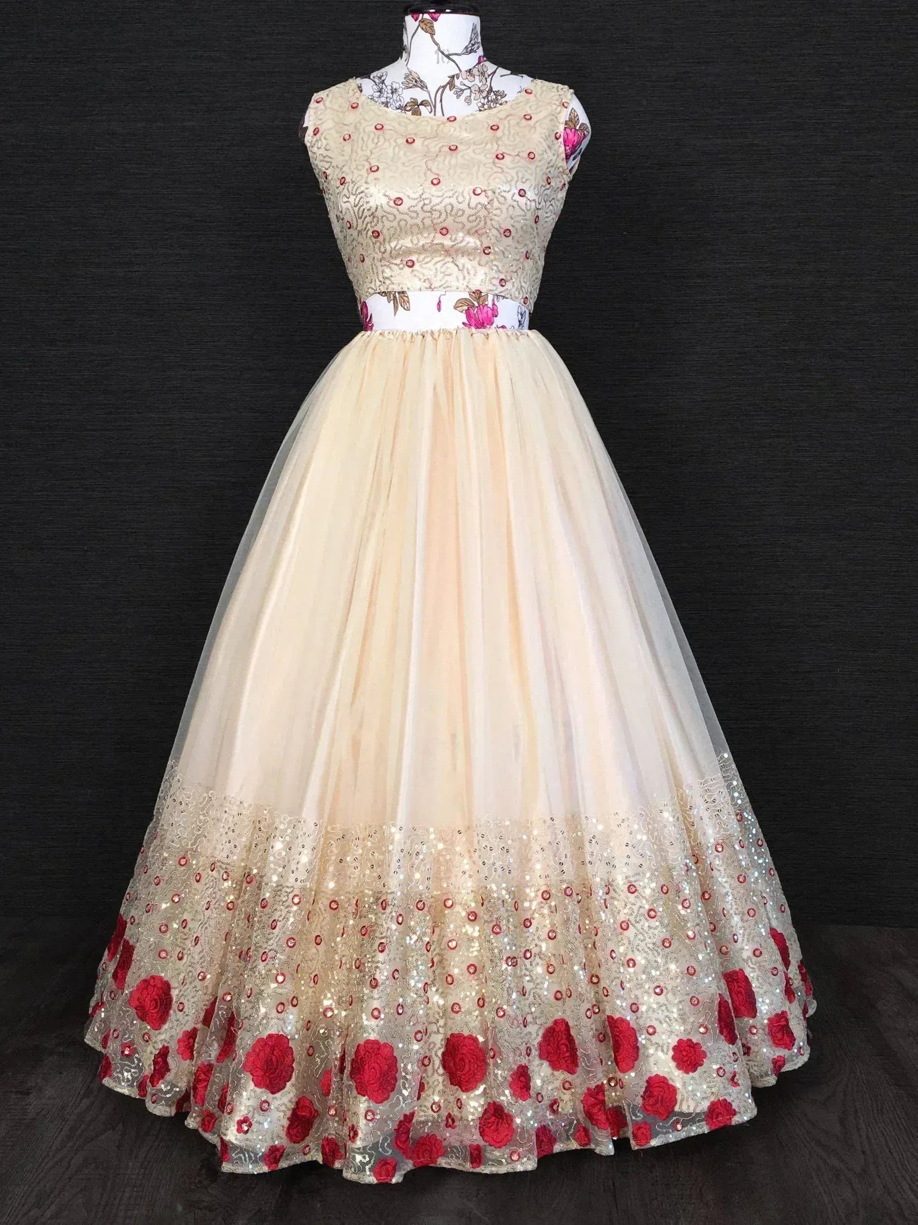 Cream ethnic gown with red floral embroidery and sequin detailing, perfect for Indian weddings and parties