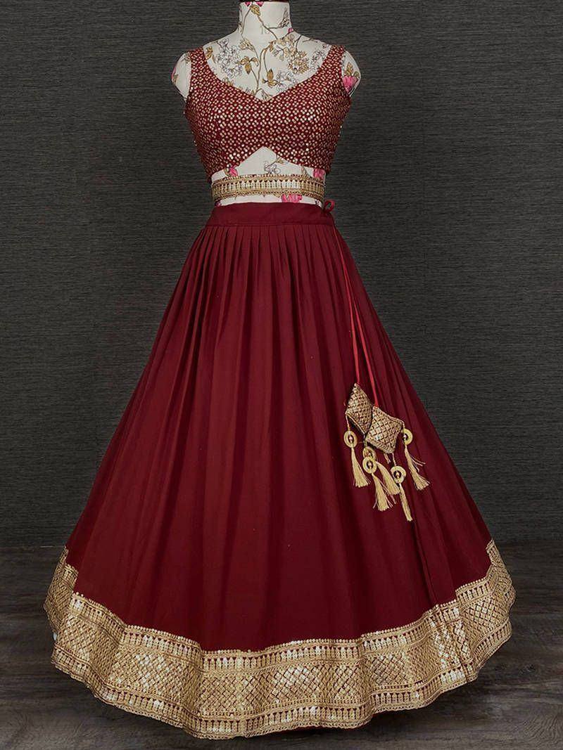 Maroon lehenga choli with gold embroidery and tassel details, ethnic Indian wear