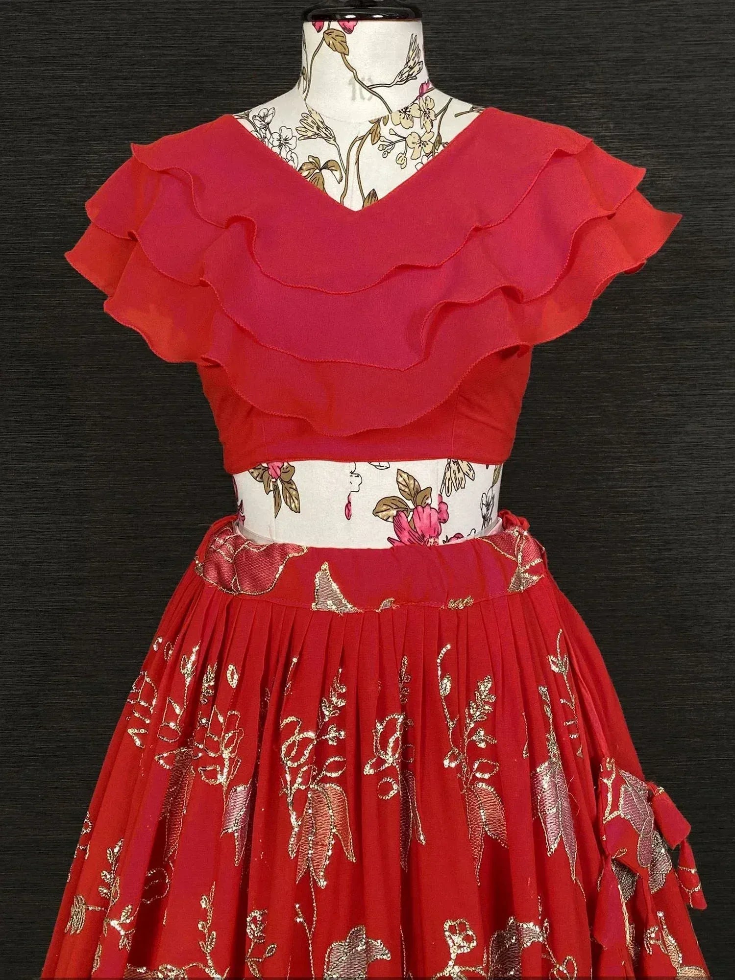 Red ethnic gown with ruffled top and gold floral embroidery, perfect for Indian festive occasions